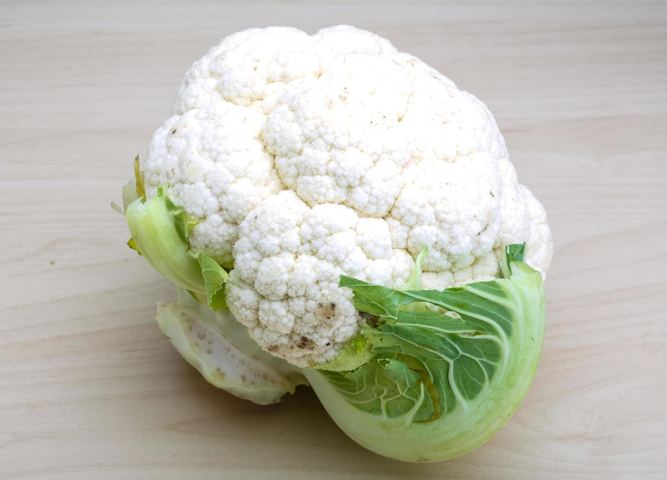 Cauliflower on wooden background photo