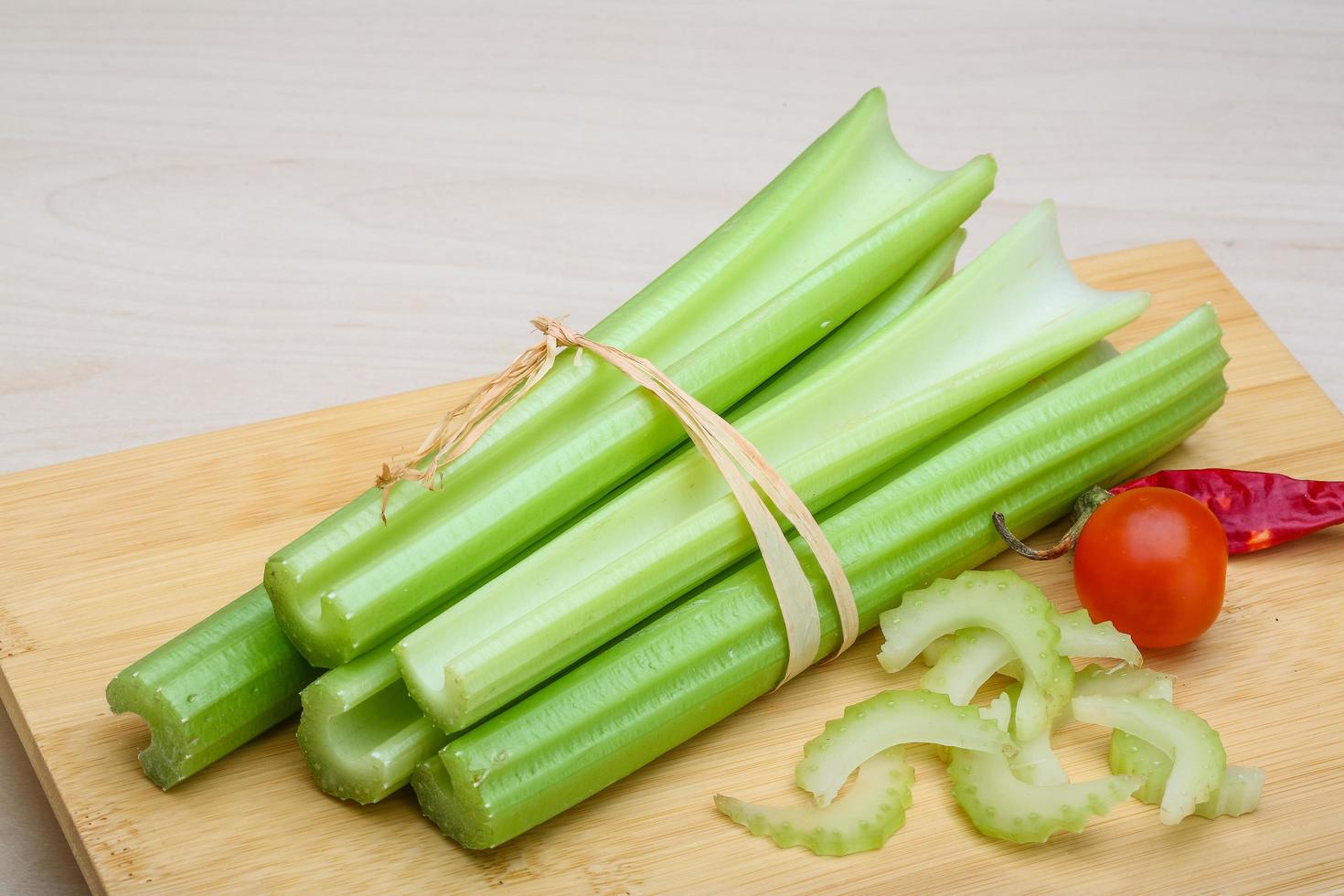 Celery on wooden board and wooden background photo