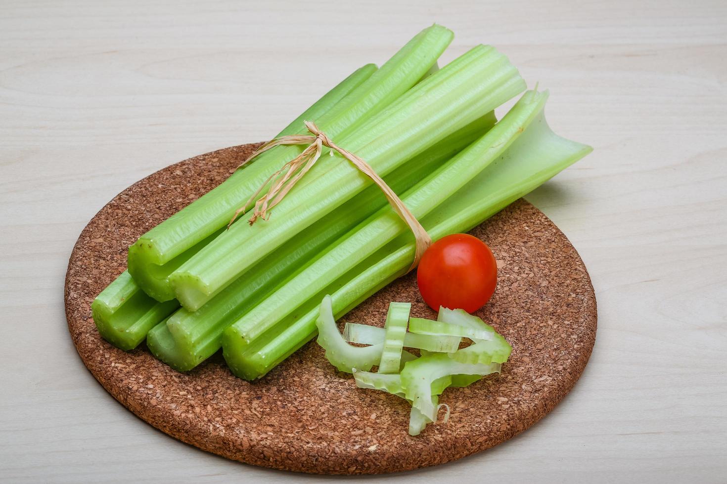 Celery on wooden board and wooden background photo