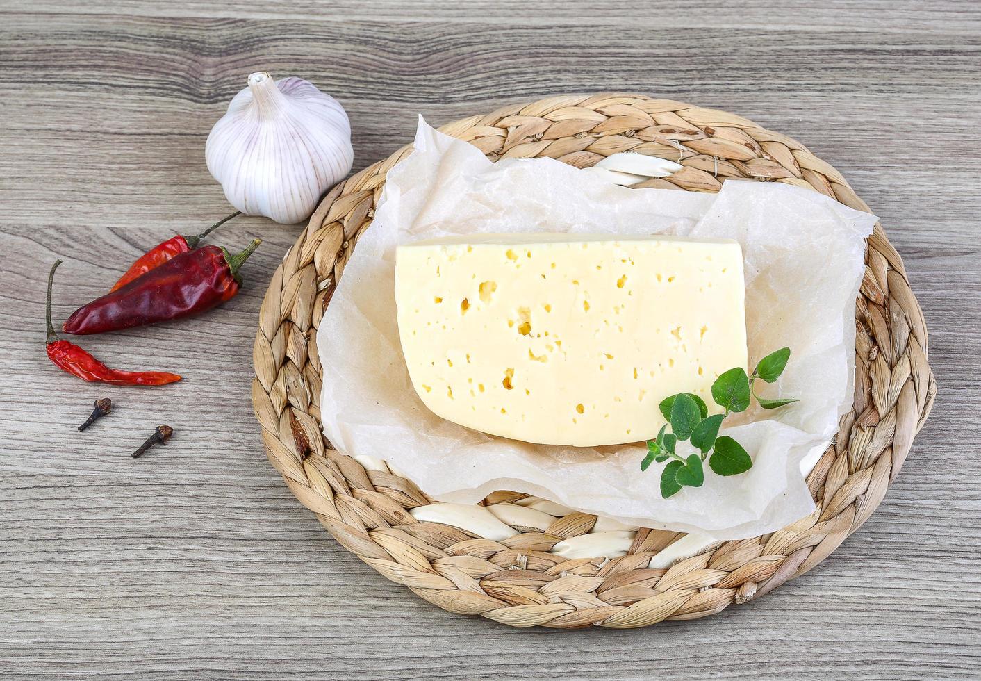 Cheese on wooden board and wooden background photo