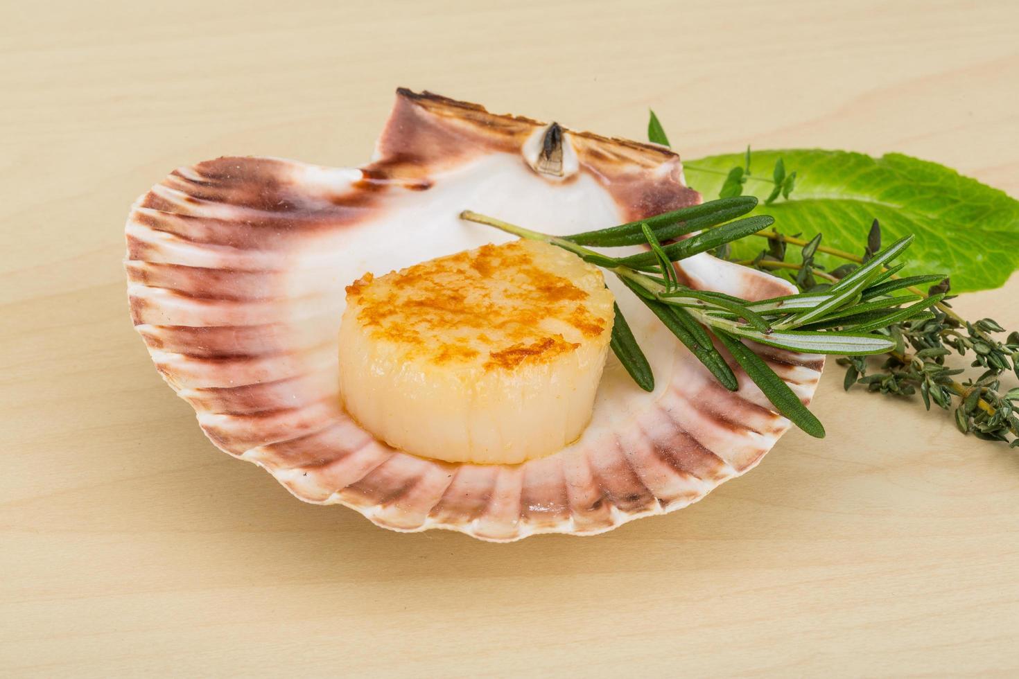 Grilled scallops in a bowl on wooden background photo