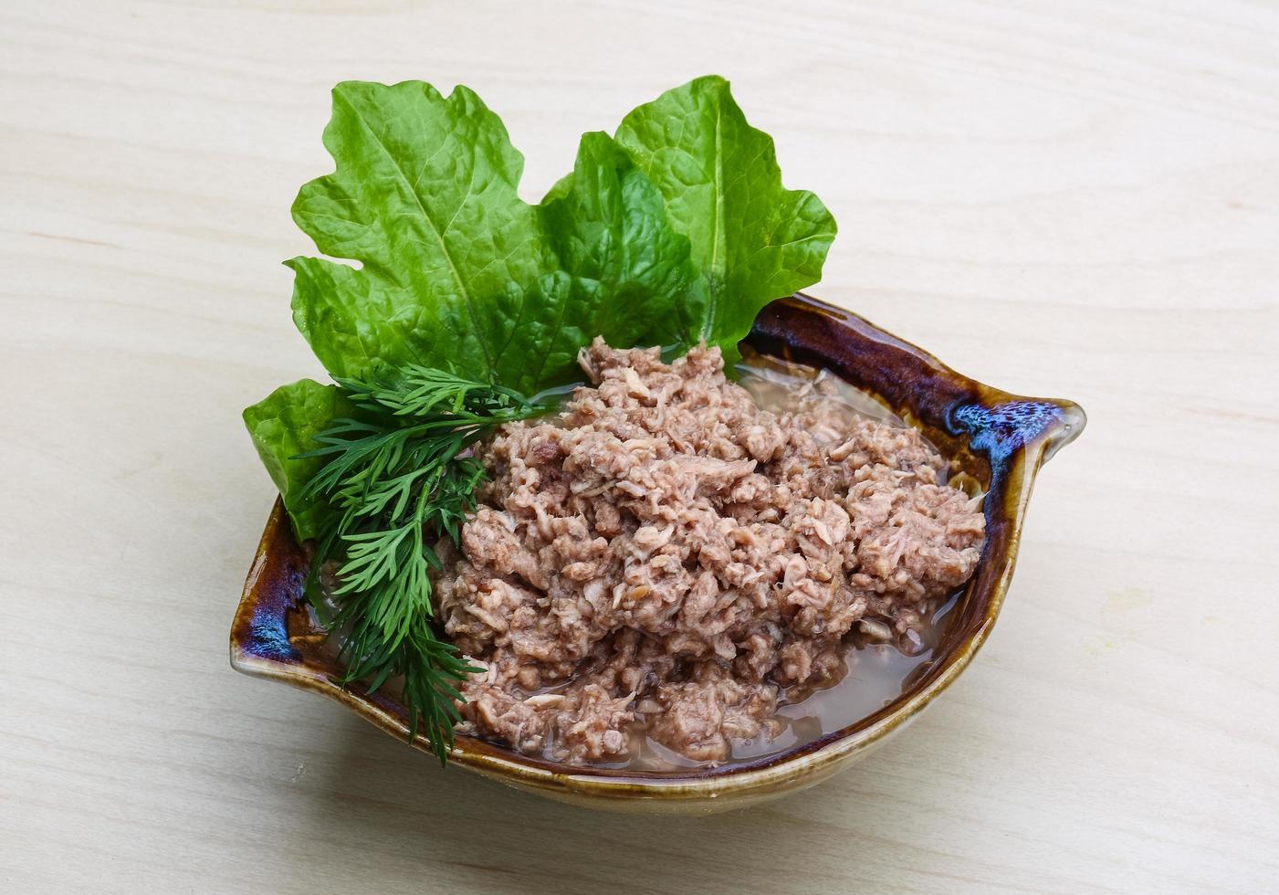 Cannded runa in a bowl on wooden background photo