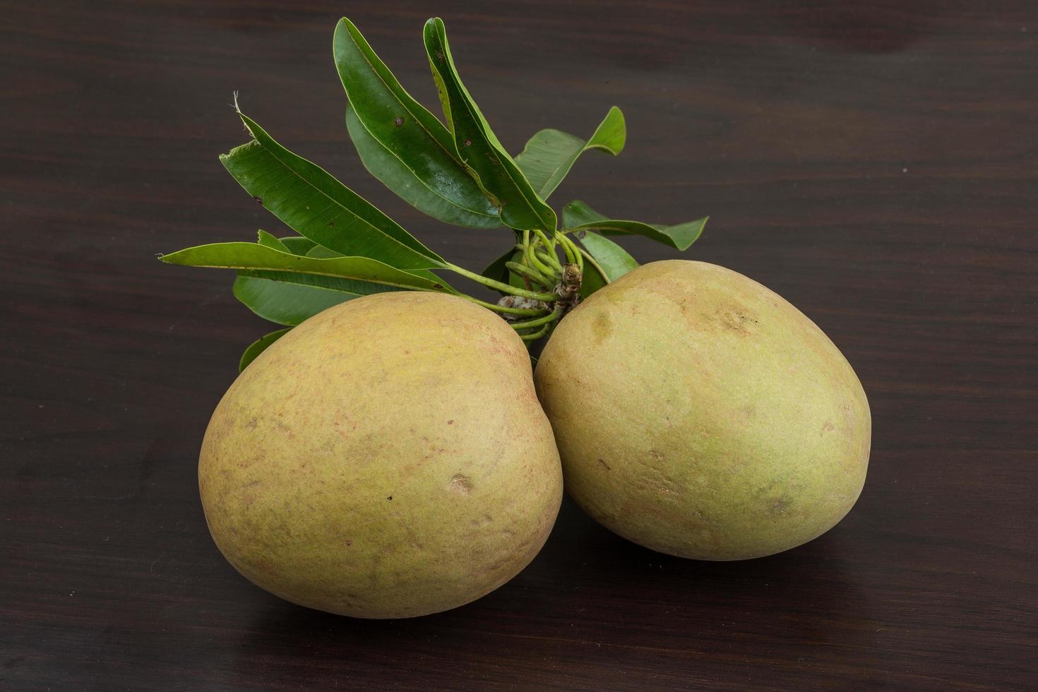 Sapodilla on wooden background photo