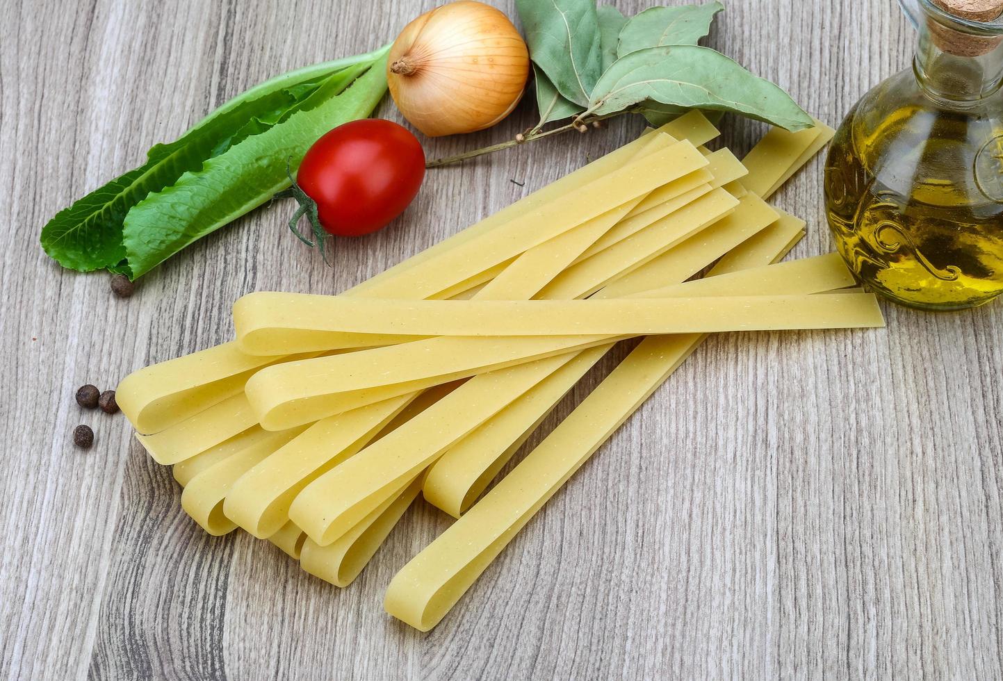 Fettuccine on wooden background photo