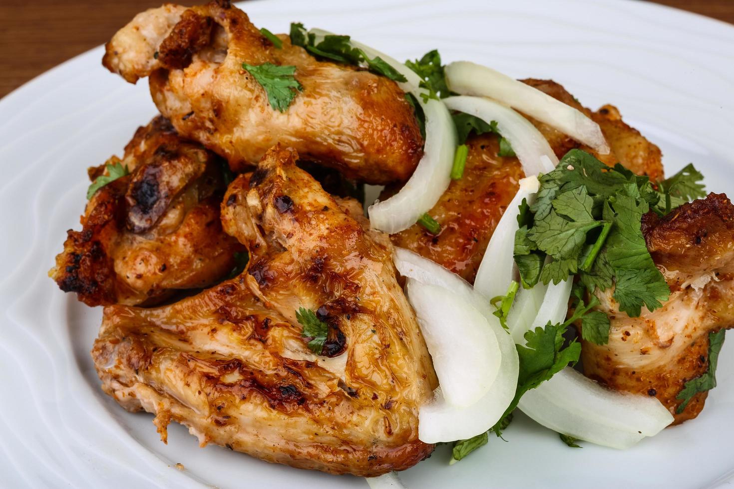 Chicken wings on the plate and wooden background 12511726 Stock Photo