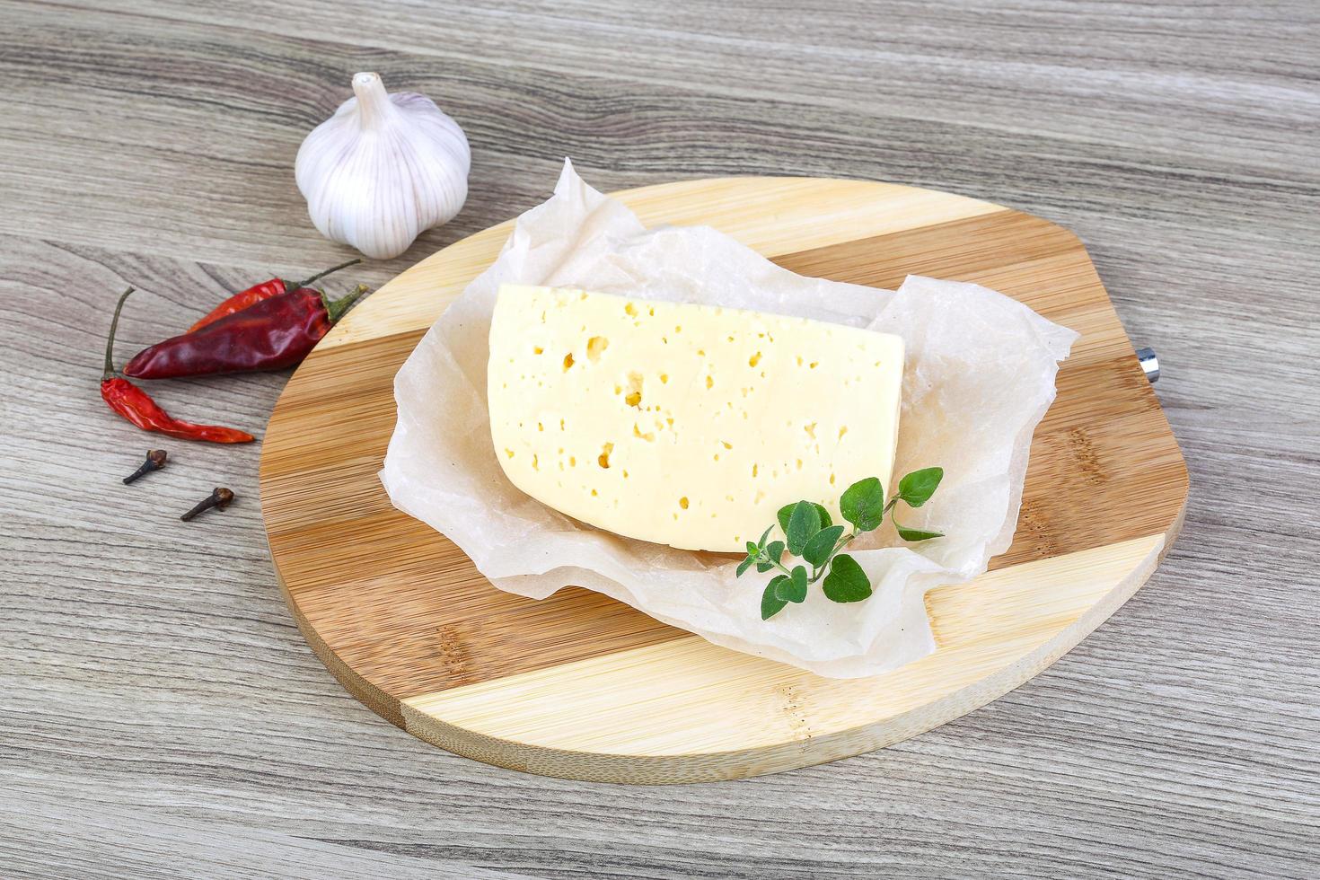 Cheese on wooden board and wooden background photo