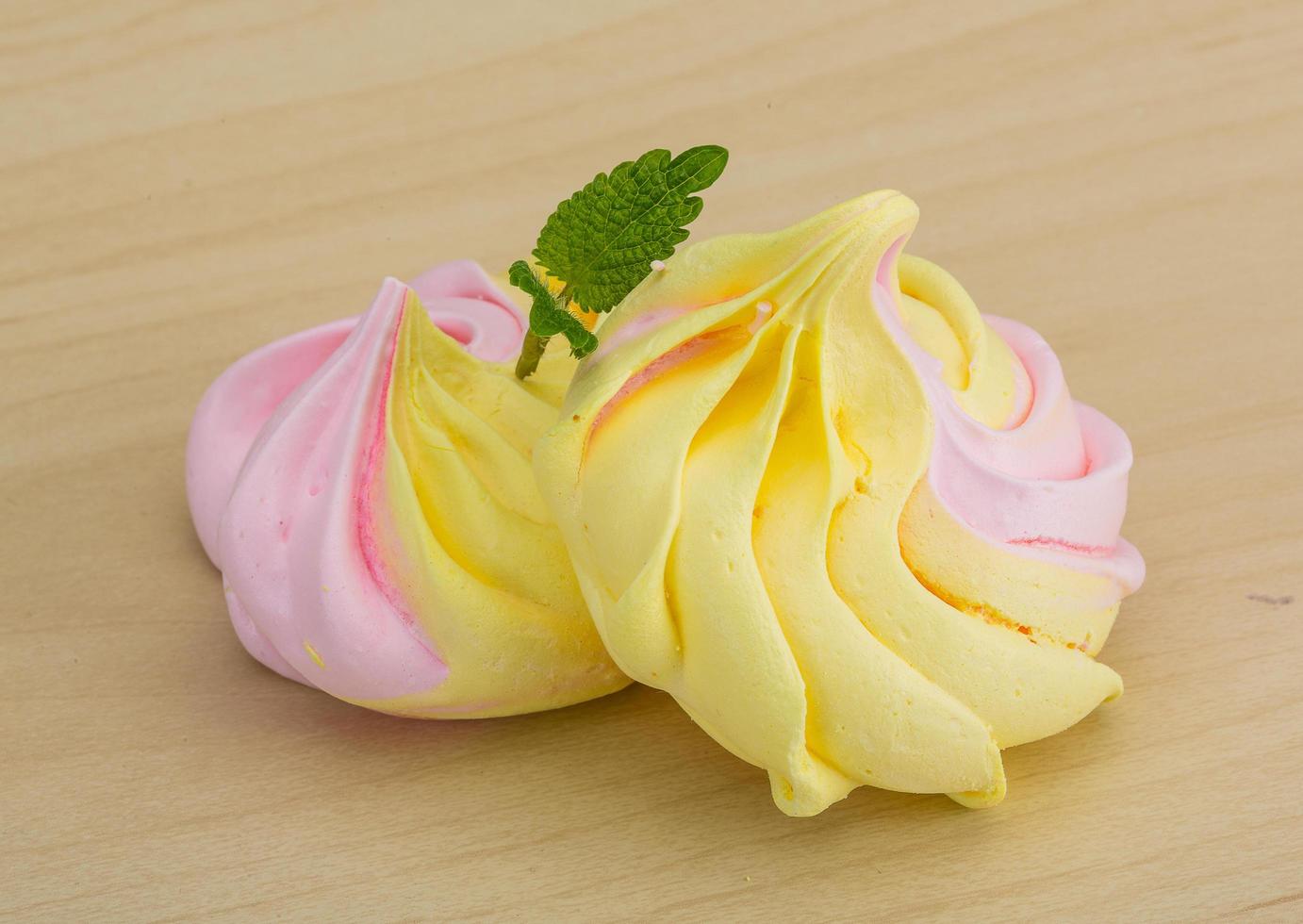Meringue on wooden background photo
