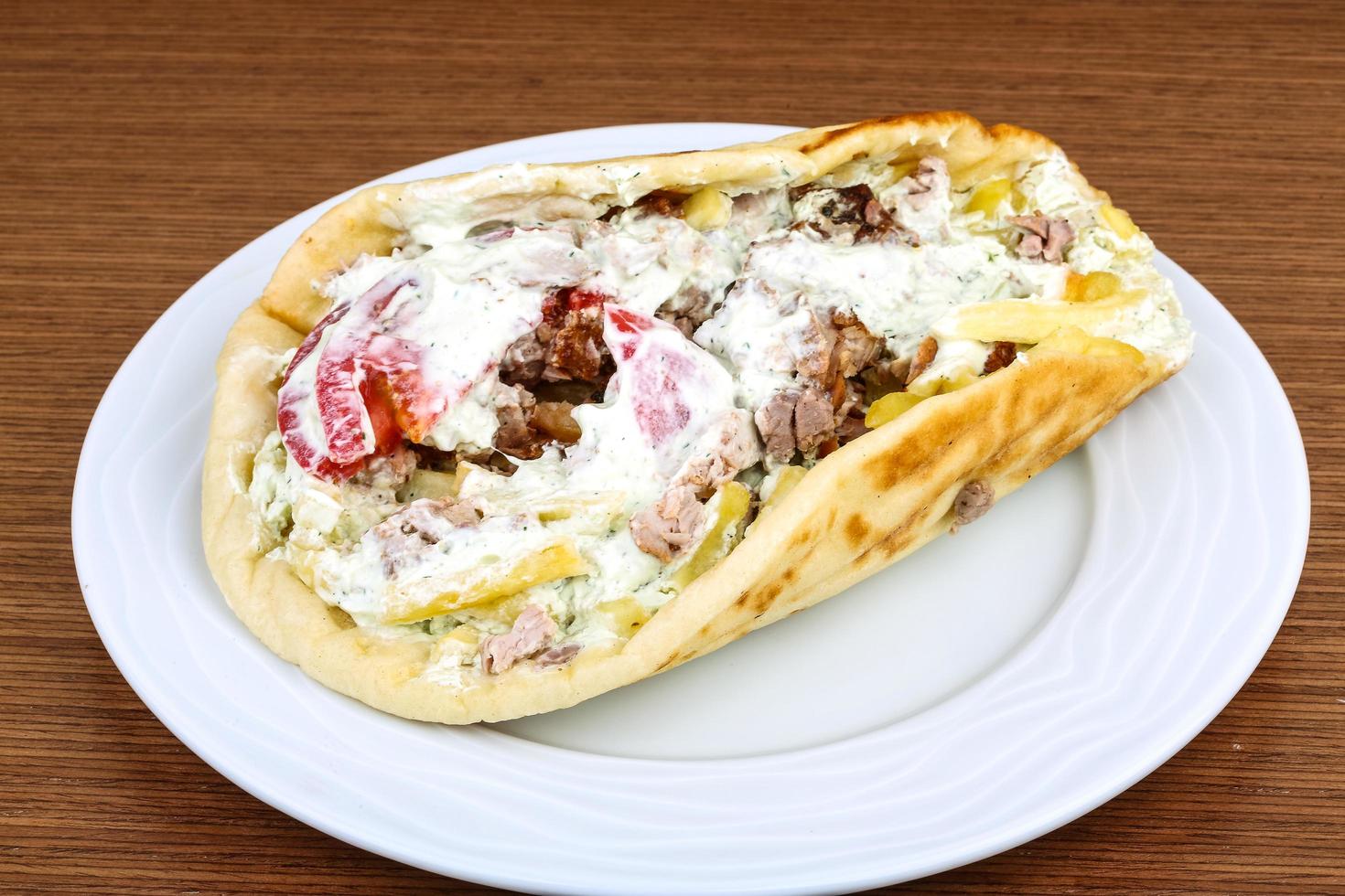 Souvlaki on the plate and wooden background photo