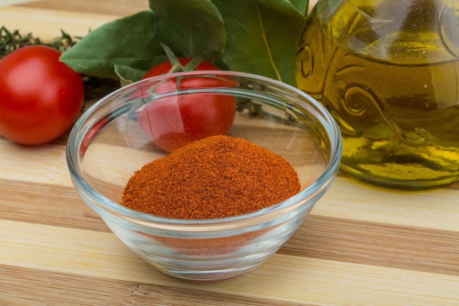 Paprika powder in a bowl on wooden background photo