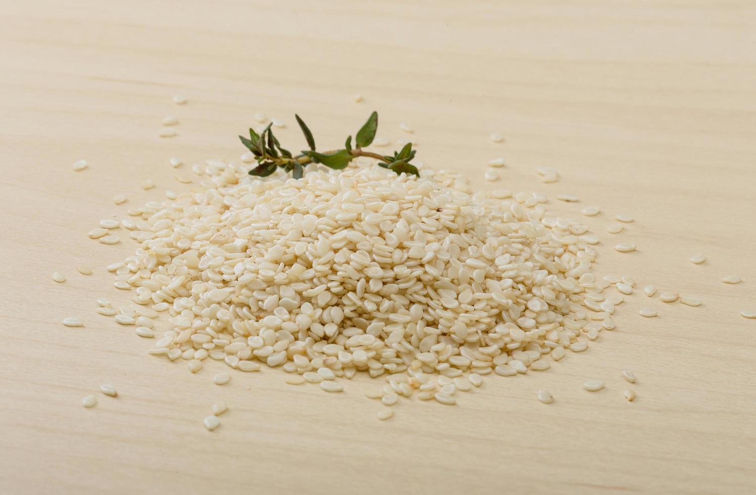 Sesame seeds on wooden background photo