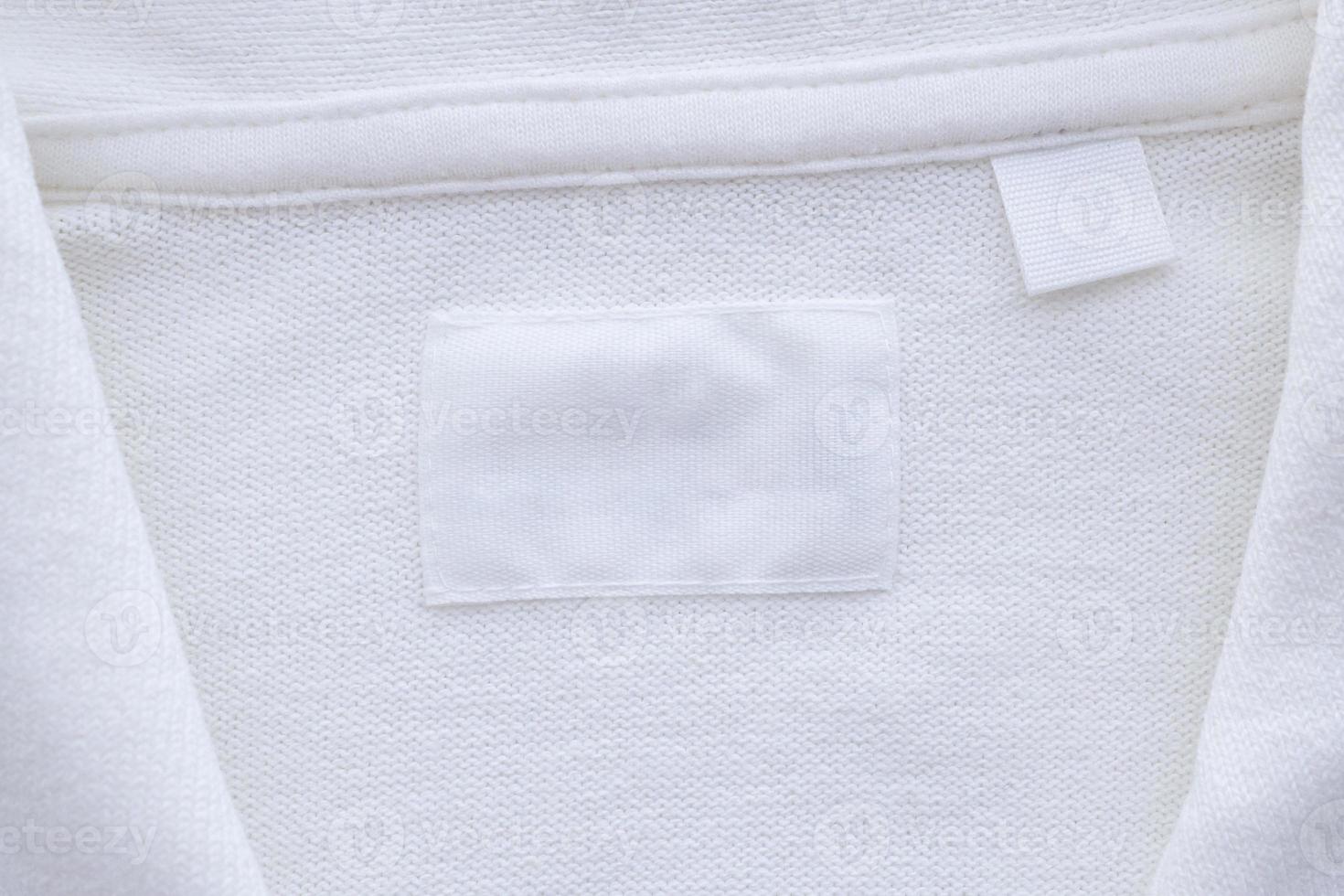 Blank white clothes label on new shirt background photo