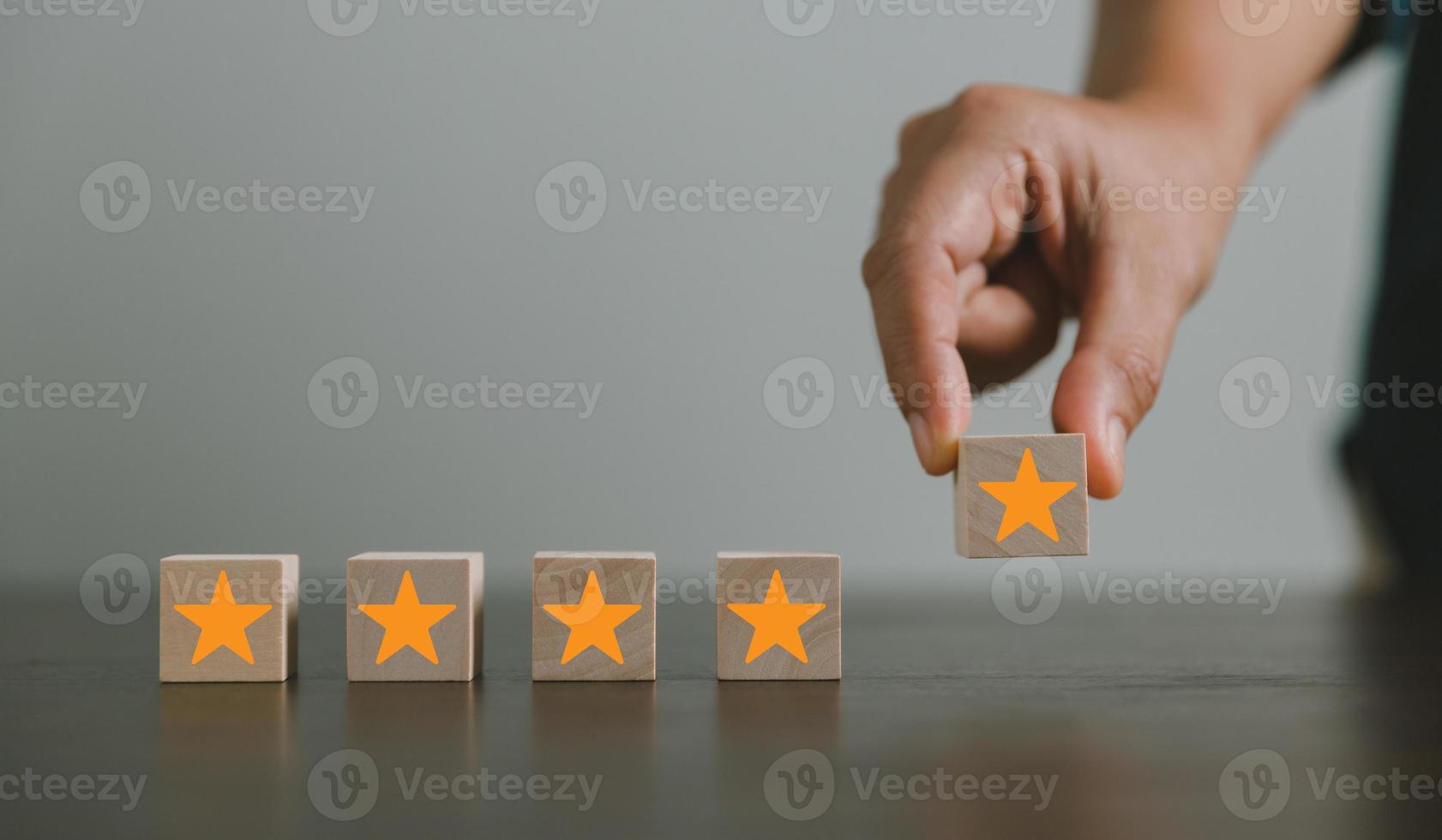 Satisfaction survey concept. Customer services best excellent business rating experience. Hand of business chooses a smile face on wood block circle. 5 Star Satisfaction. People feel great product. photo