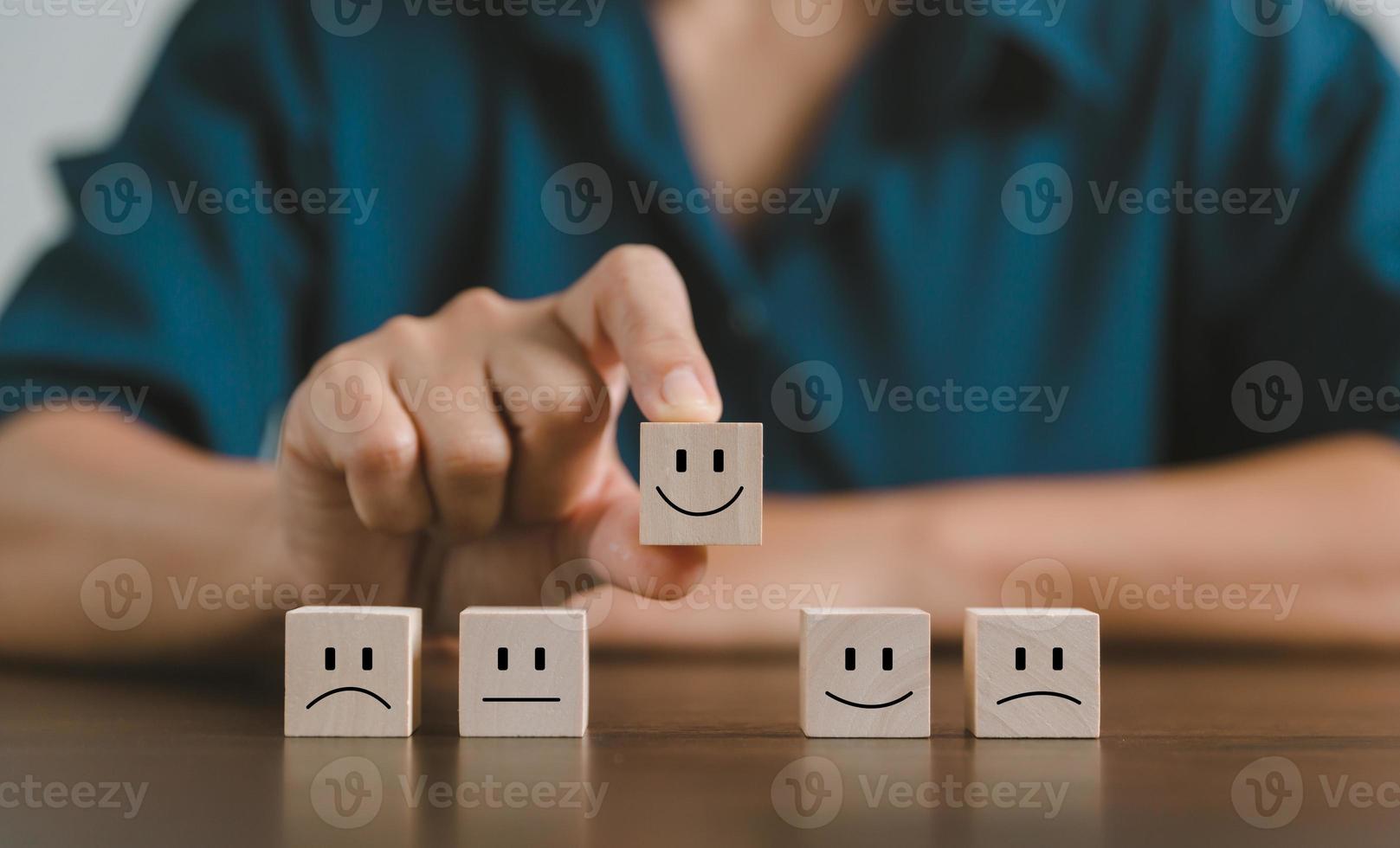 Satisfaction survey concept. Customer services best excellent business rating experience. Hand of business chooses a smile face on wood block circle. 5 Star Satisfaction. People feel great product. photo