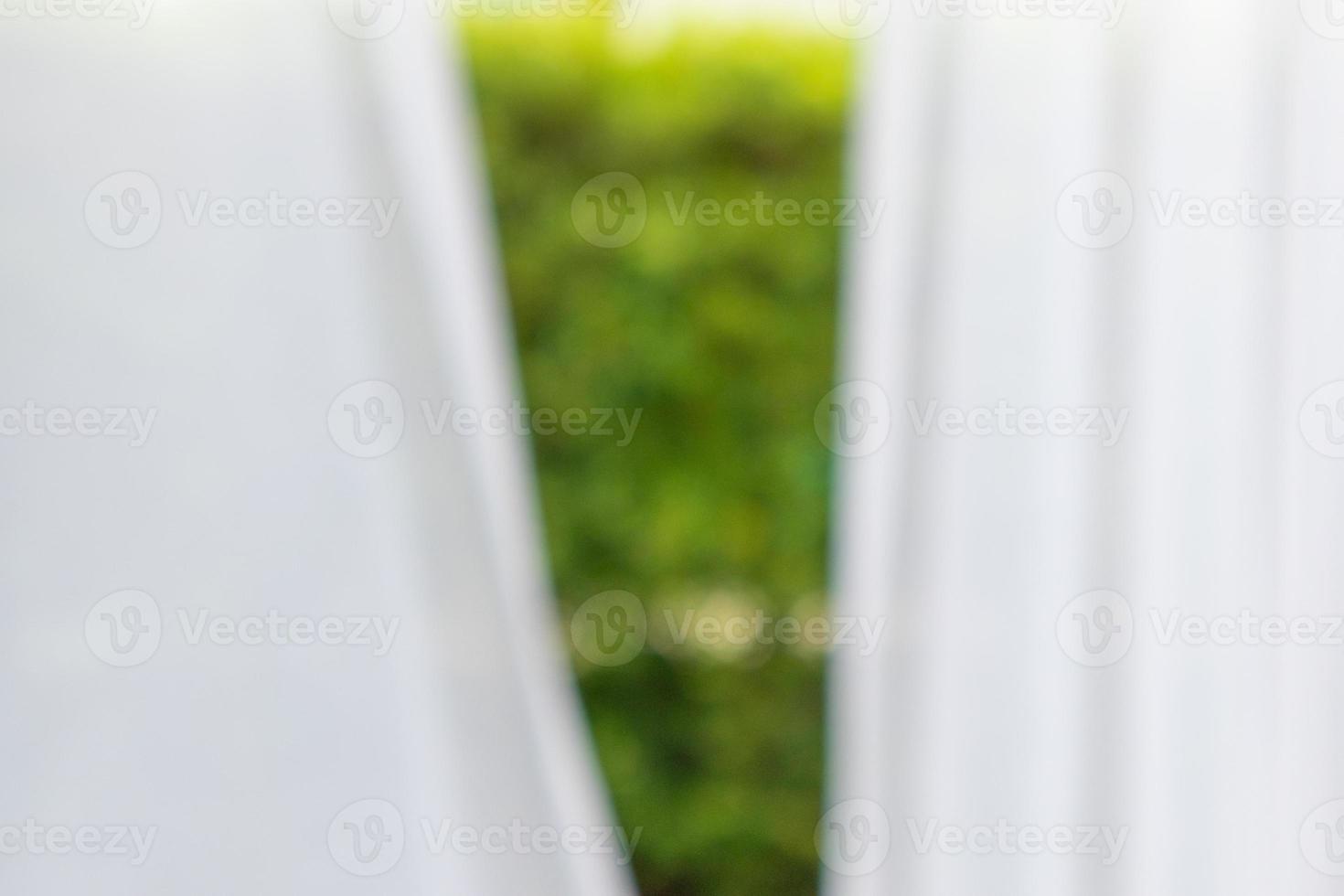 Abstract blur curtain window with green garden background photo