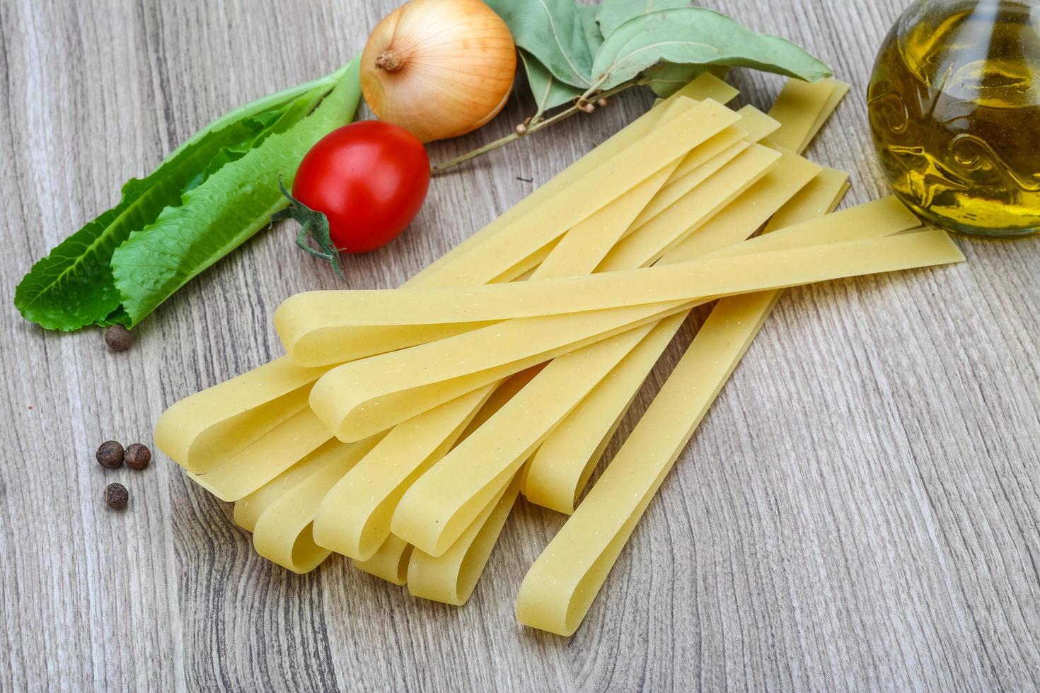 Fettuccine on wooden background photo