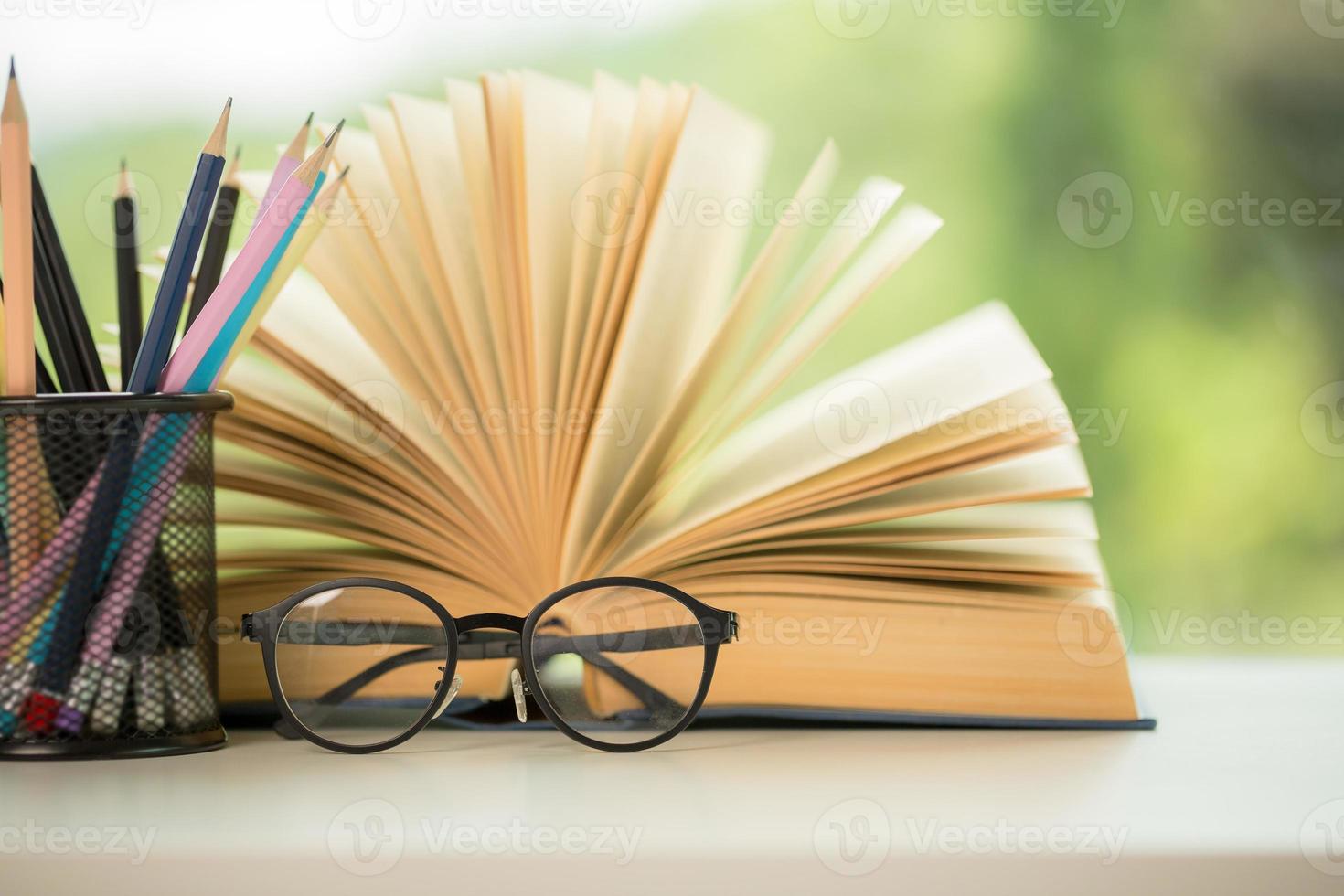 Object education green nature background with stack of ancient books or old bible, open paper book on wooden table with copy space. concept of back to school, research study photo