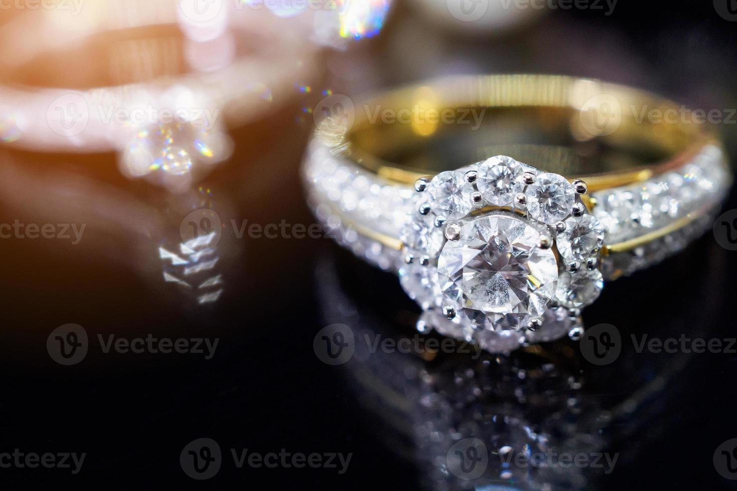 Jewelry diamond rings with reflection on black background photo