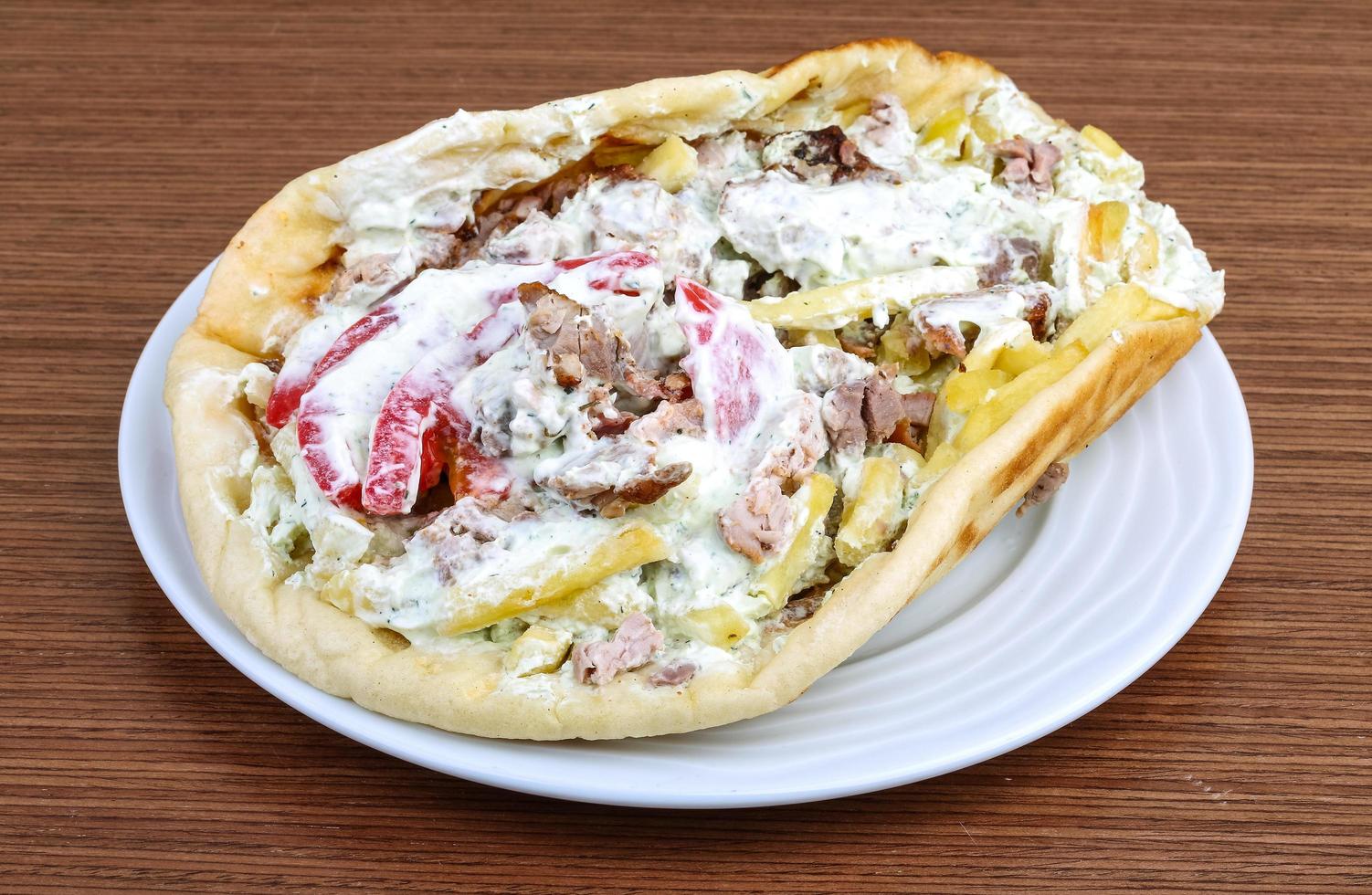 Souvlaki on the plate and wooden background photo