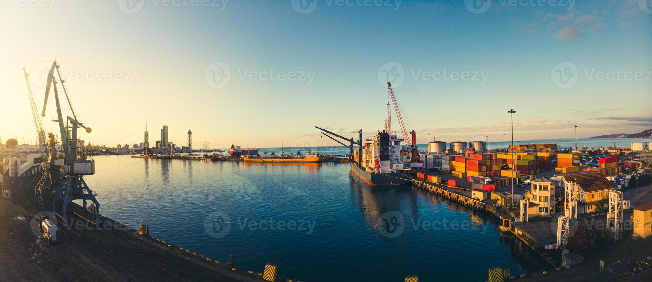 Batumi, Georgia, 2021 - Cargo ship in Batumi seaport docked with loaded container . Sea transportation in black sea caucasus photo