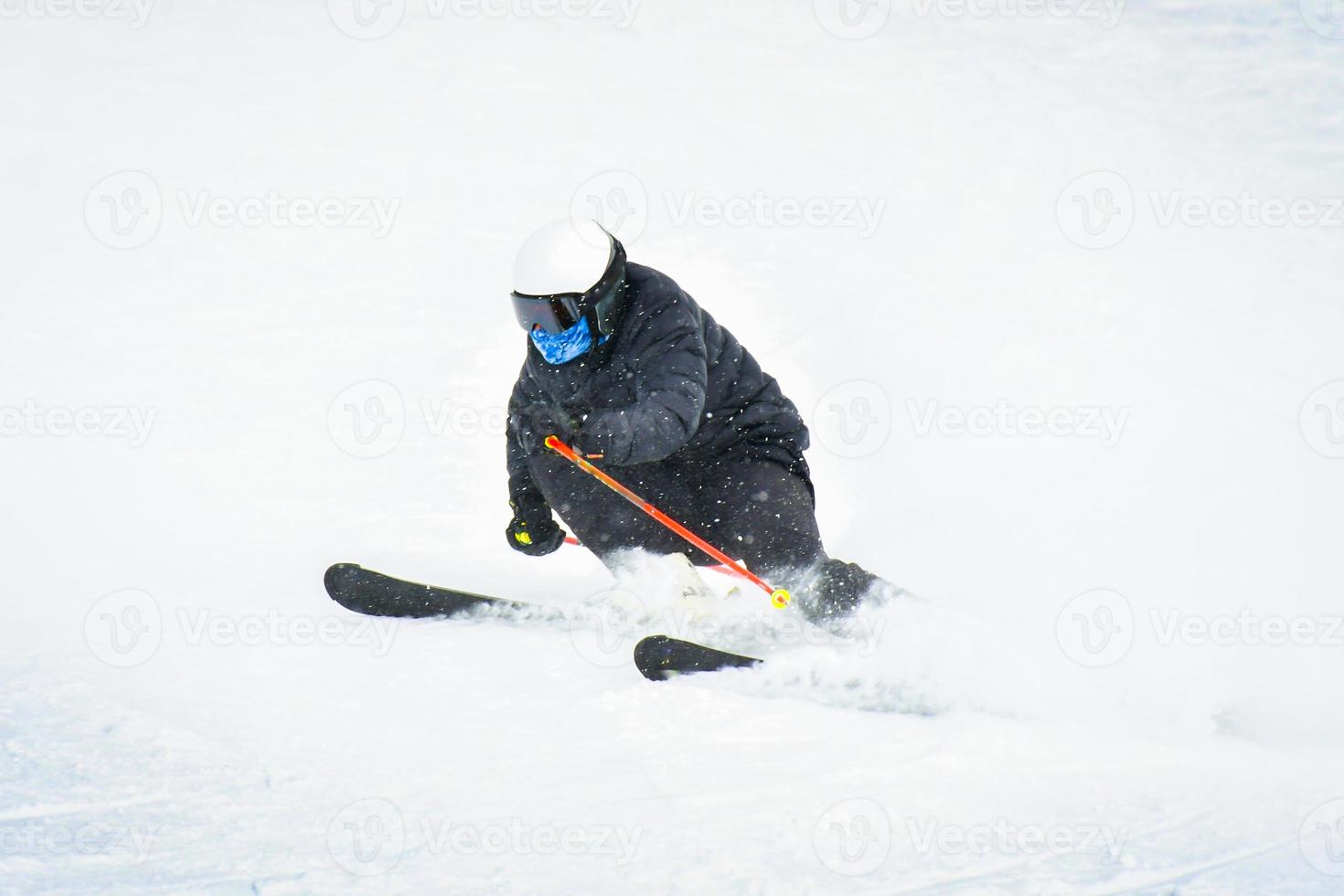 Professional skier at full speed ski downhill turn on fresh snow do carving in ski resort while training for competition in Gudauri ski resort in Georgia photo