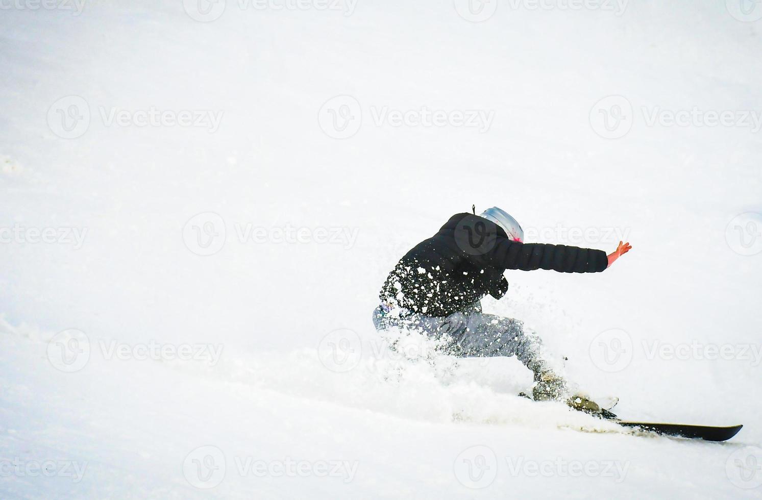 Beginner skier with no gloves and helmet fall on snow hard. Bad clothing in ski resort concept. Winter holiday vacation preparation photo