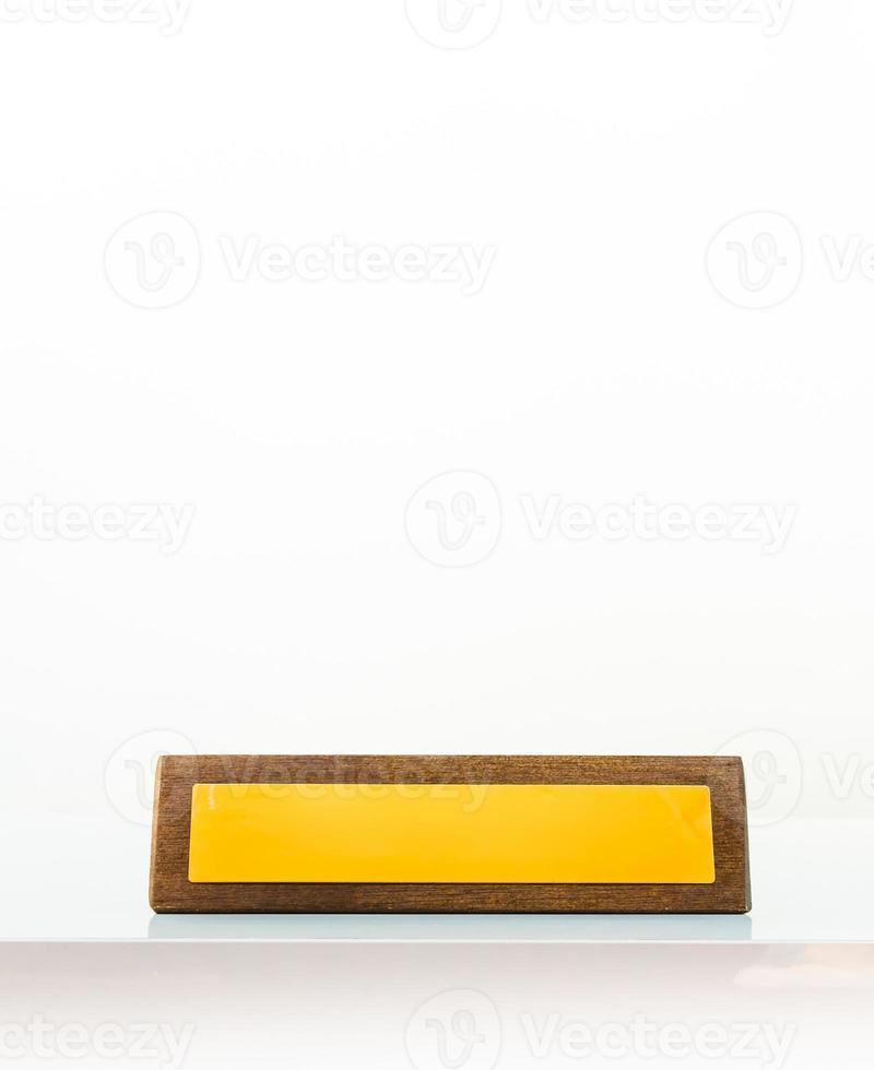 Wooden yellow business office plate in white background with title blank copy paste space. Yellow empty space position plate in office isolated in white background photo