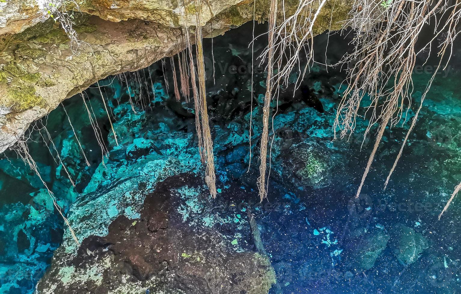 Blue turquoise water limestone cave sinkhole cenote Tajma ha Mexico. photo