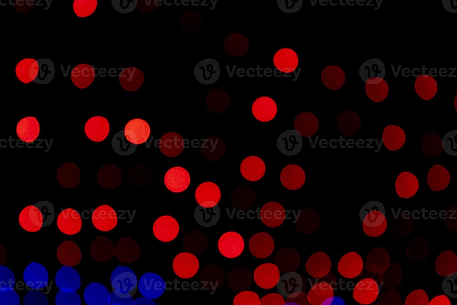 Red Defocus Abstract bokeh light effects on the night black background texture photo