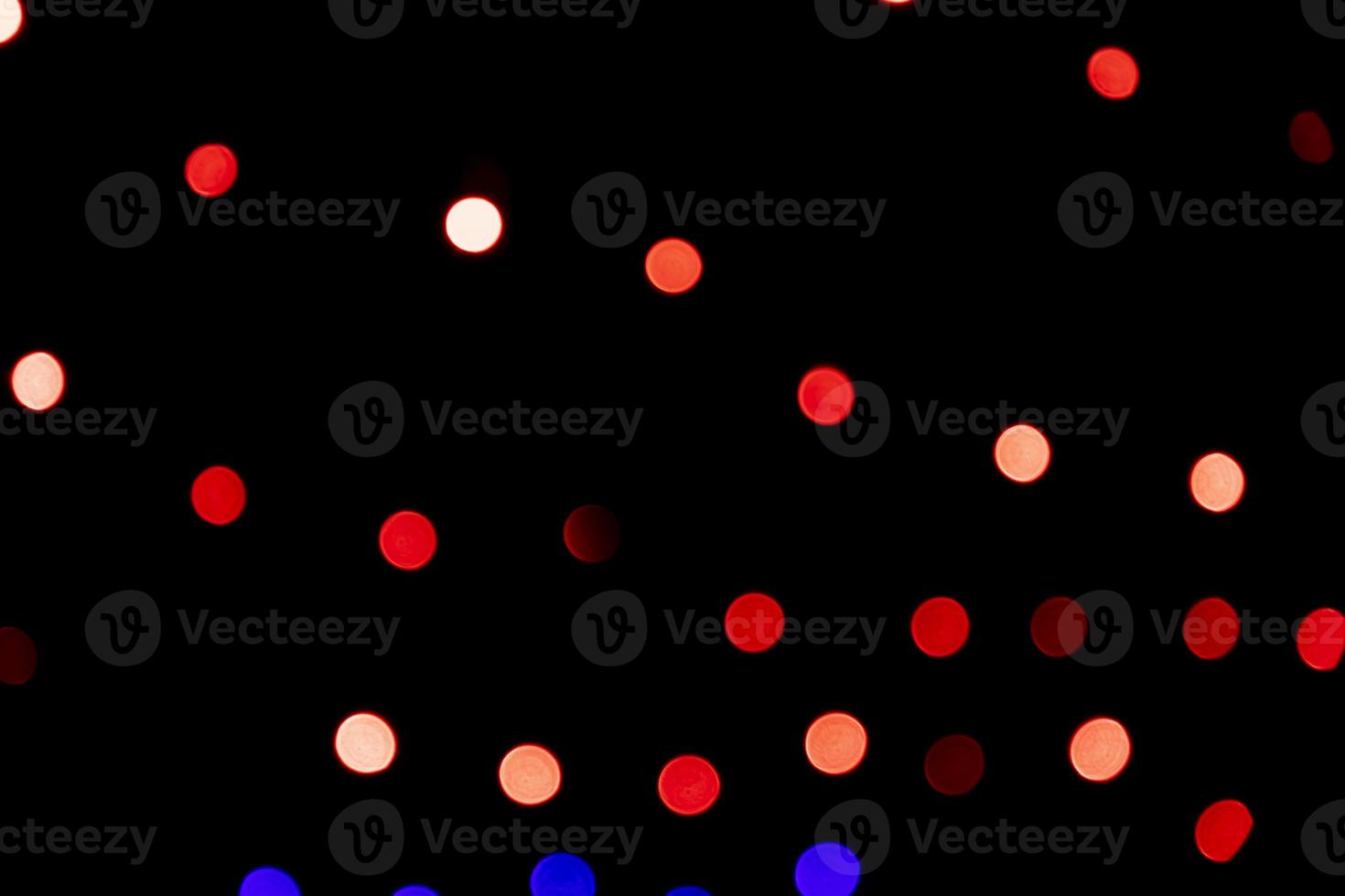 Red Defocus Abstract bokeh light effects on the night black background texture photo