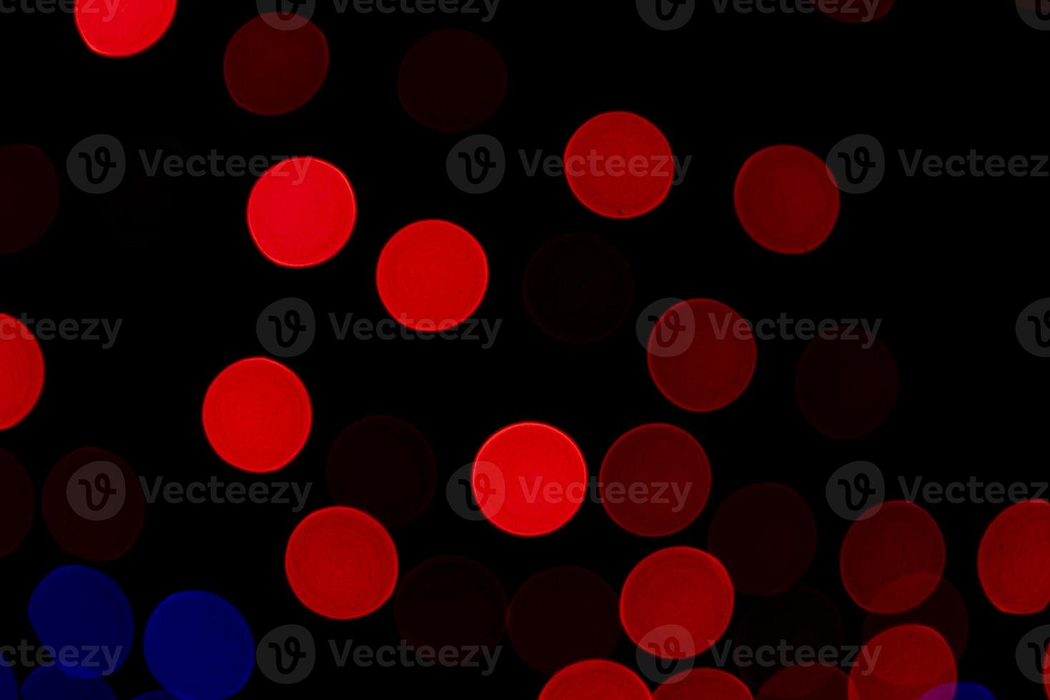 Red Defocus Abstract bokeh light effects on the night black background texture photo