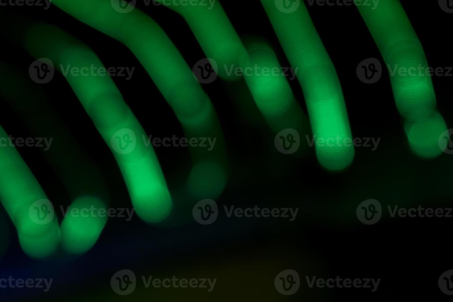 Green Defocus Abstract bokeh light effects on the night black background texture photo