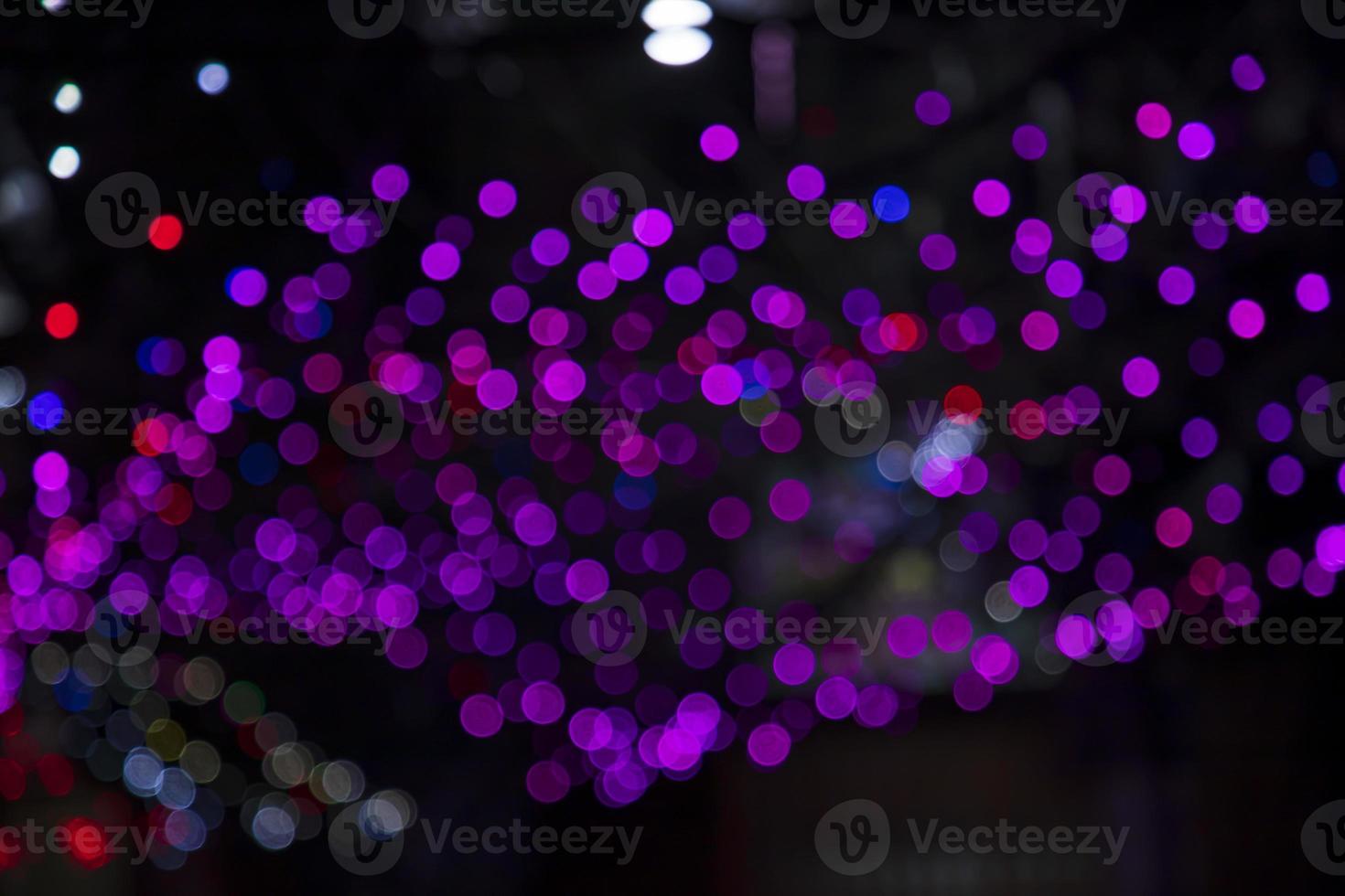 Purple pink Defocus Abstract bokeh light effects on the night black background texture photo