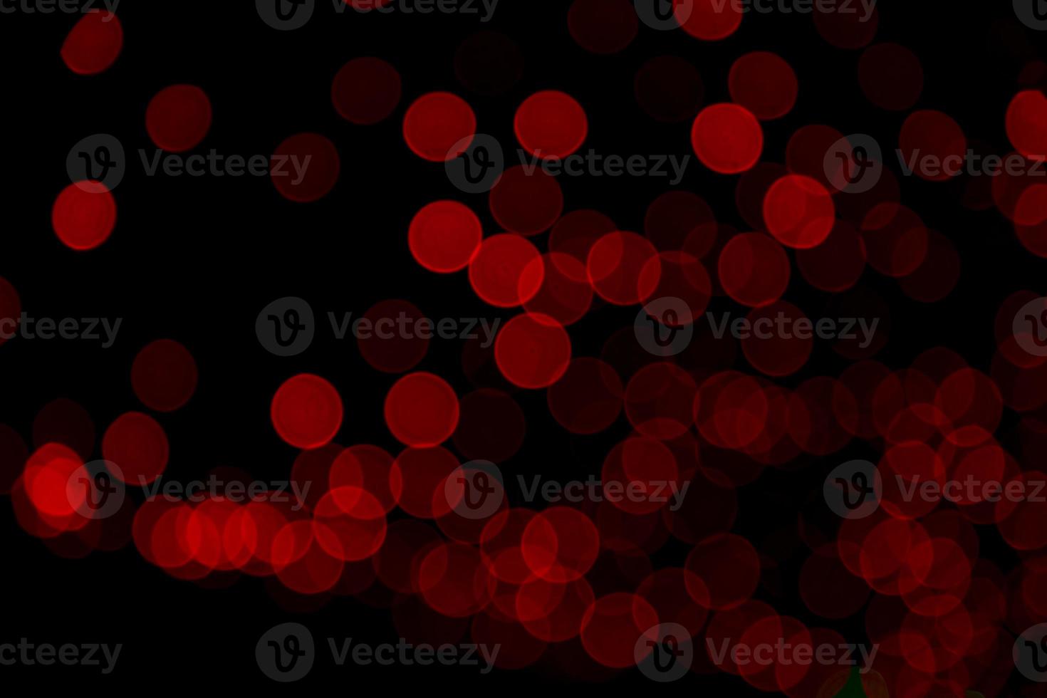 Red Defocus Abstract bokeh light effects on the night black background texture photo
