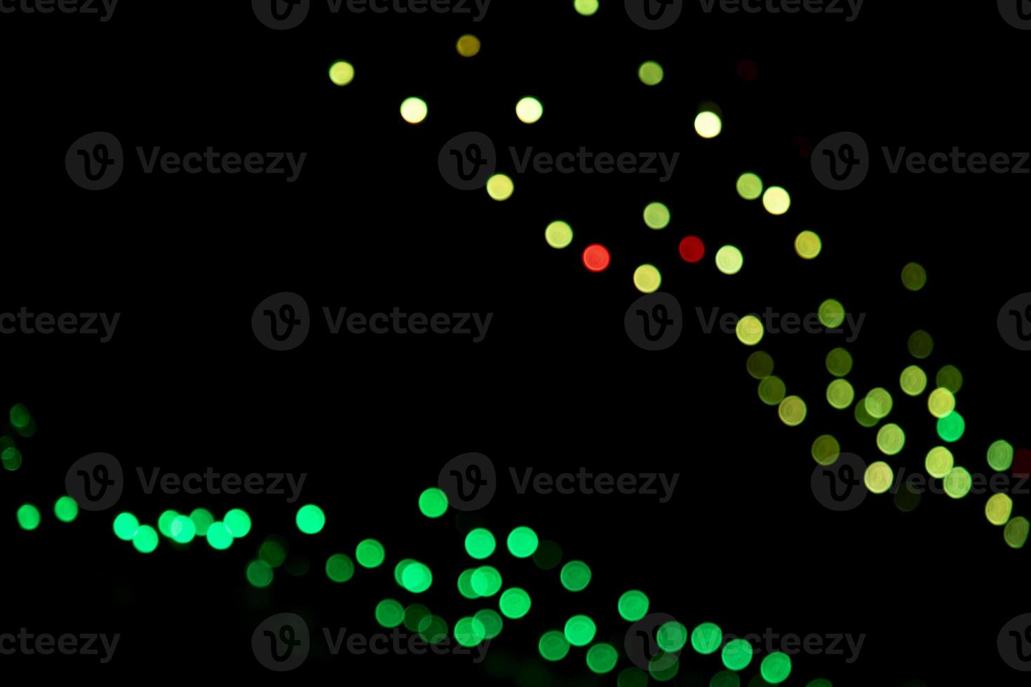 Green Defocus Abstract bokeh light effects on the night black background texture photo