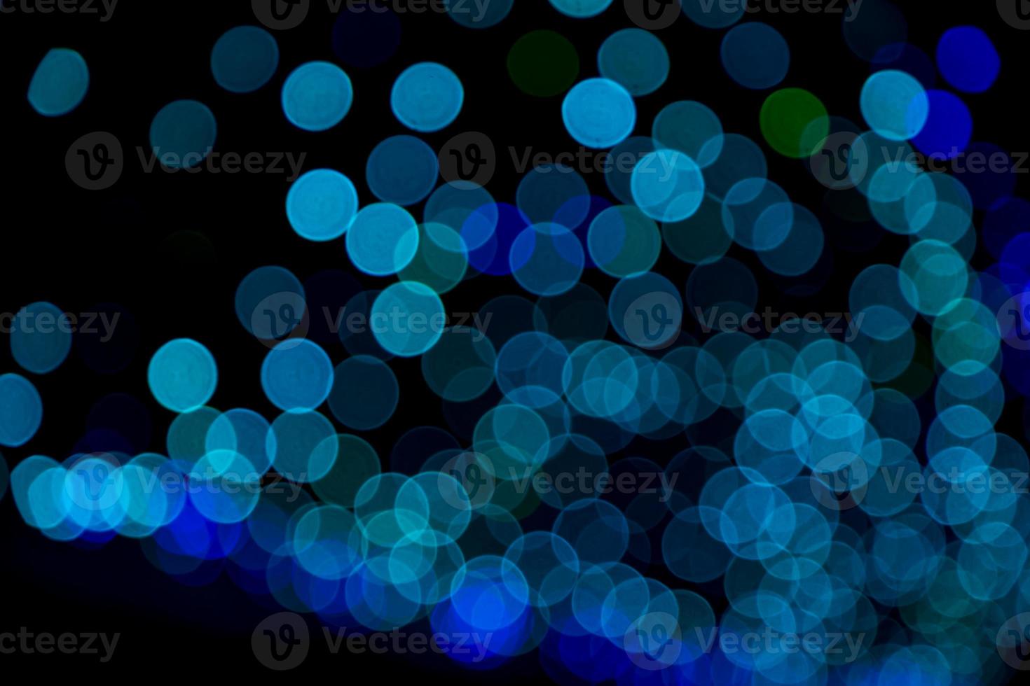 Blue Defocus Abstract bokeh light effects on the night black background texture photo