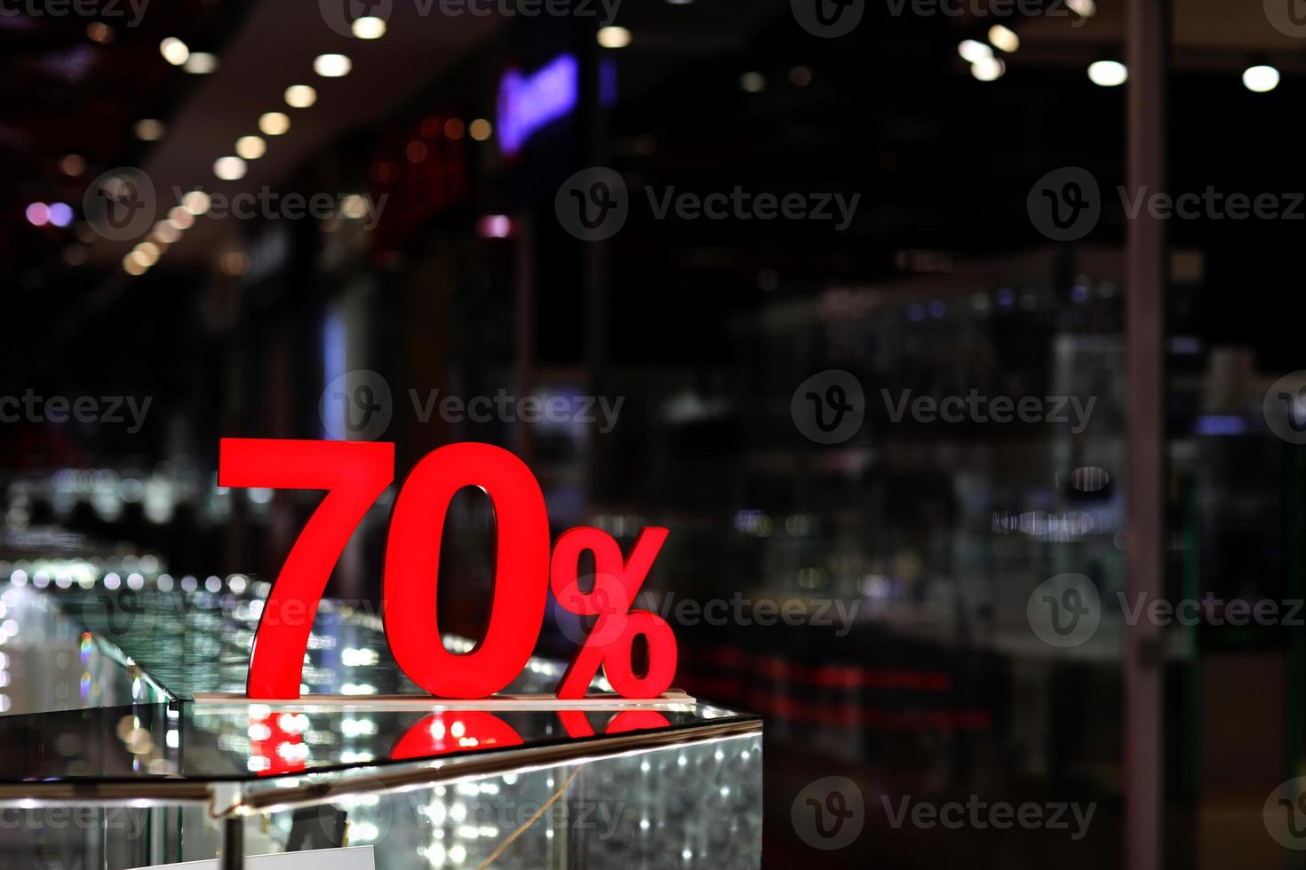 Season sale, black friday and shopping concept. Discounts in the shopping mall. Sale sign with Red label 70 percent discount. concept of seasonal winter sale, Mega sale. photo