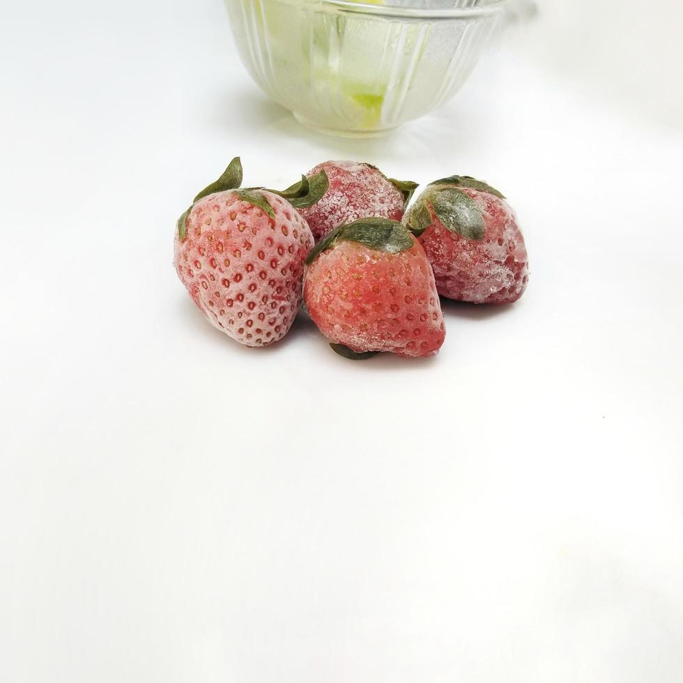 frozen strawberry isolated on white background photo