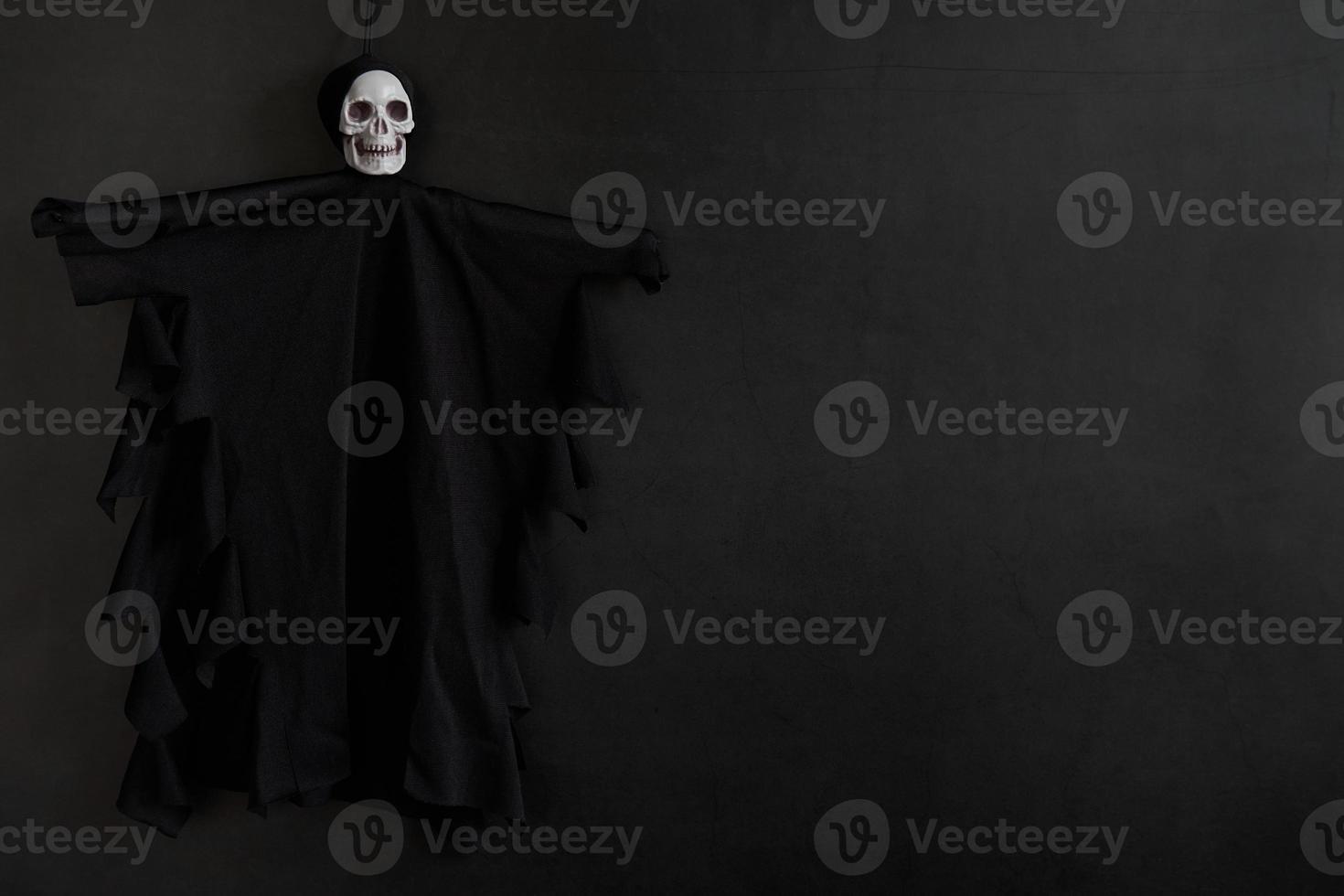 Halloween dark background with skeleton or ghost decoration and place for text photo