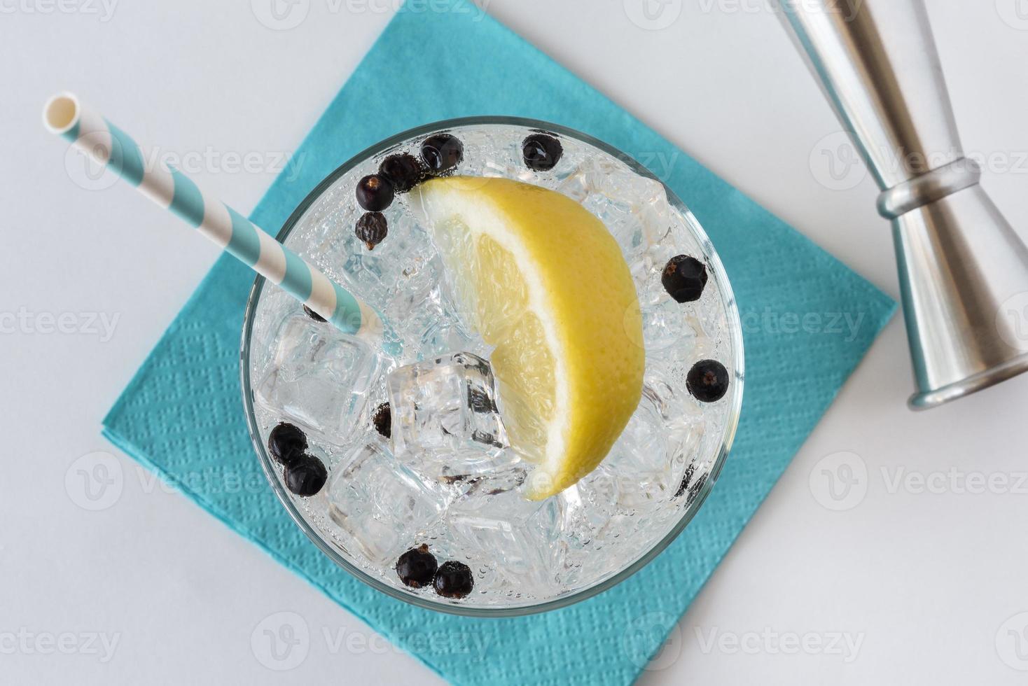 Gin and Tonic with Lemon and Blue Napkin photo