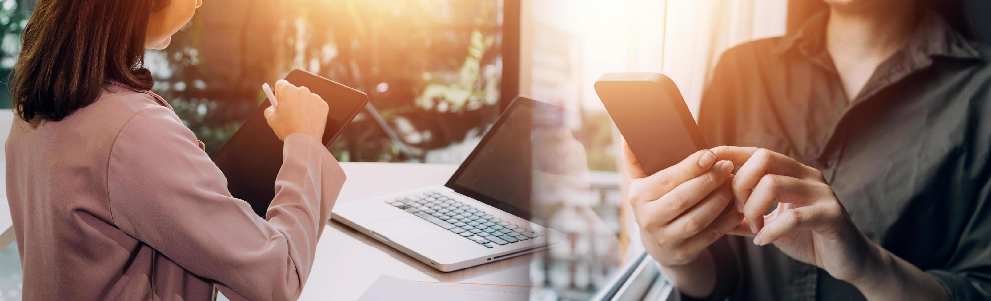Businessman hands working with finances about cost and calculator and laptop with tablet, smartphone at office in morning light photo