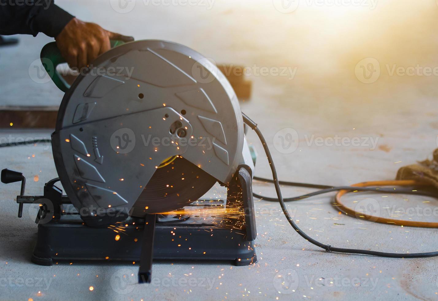 worker cutting metal. Sparks while grinding iron. photo