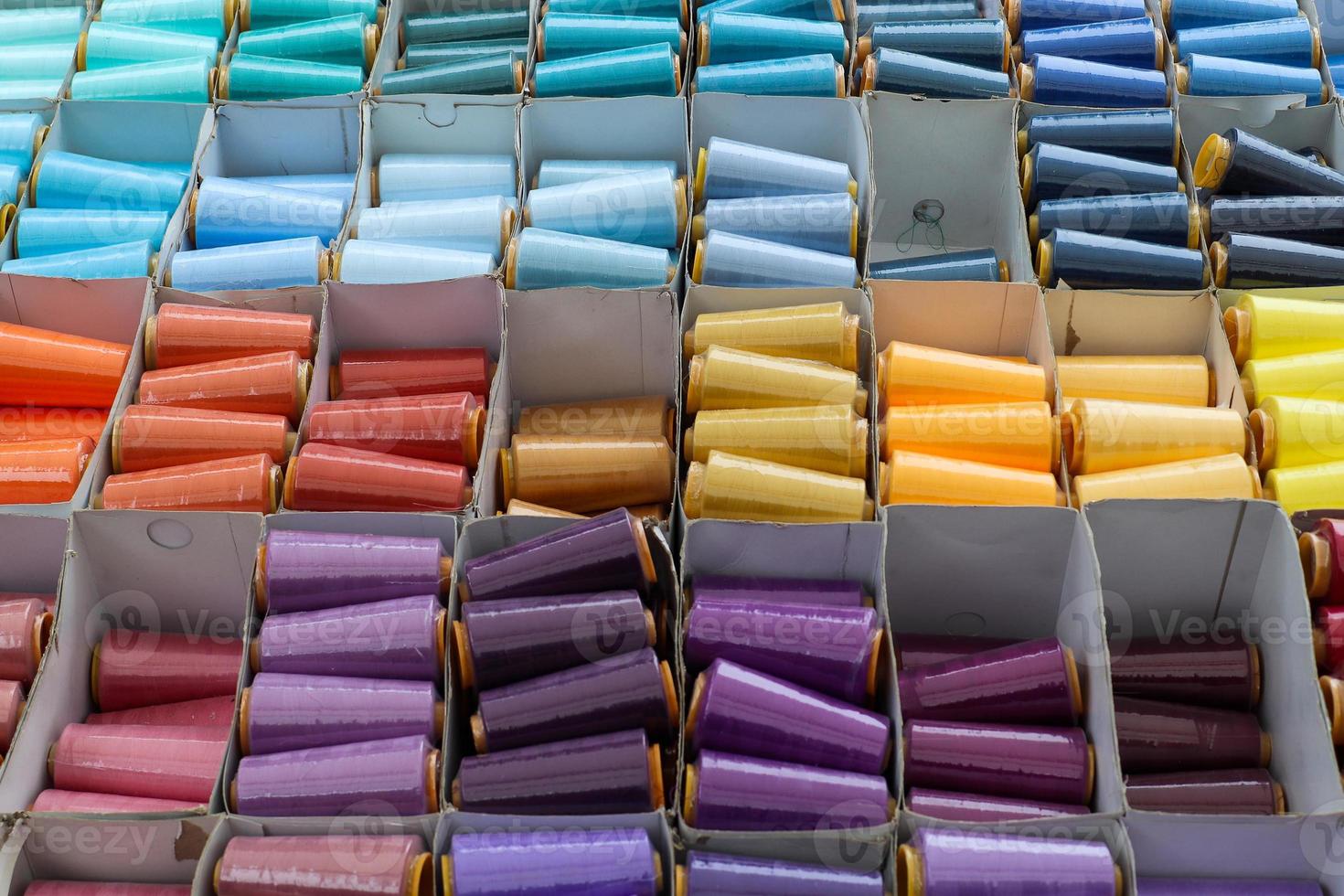 Detailed close up view on samples of cloth and fabrics in different colors found at a fabrics market photo