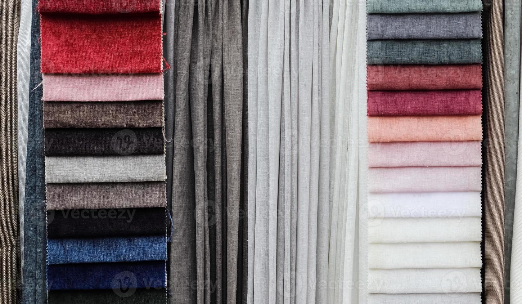 Detailed close up view on samples of cloth and fabrics in different colors found at a fabrics market photo