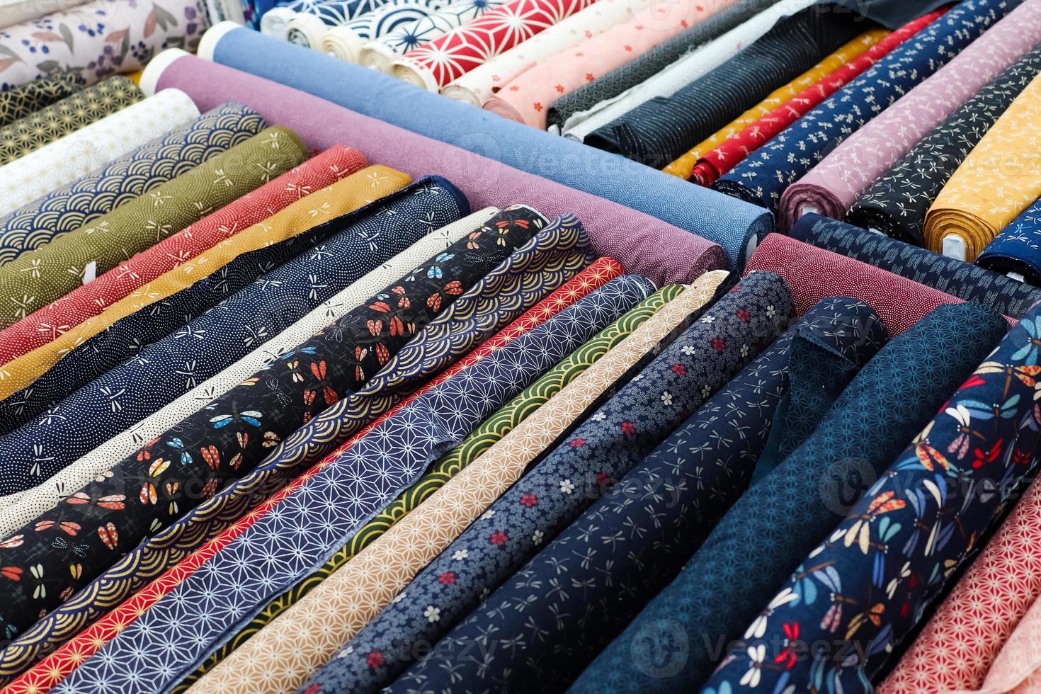 Detailed close up view on samples of cloth and fabrics in different colors found at a fabrics market photo