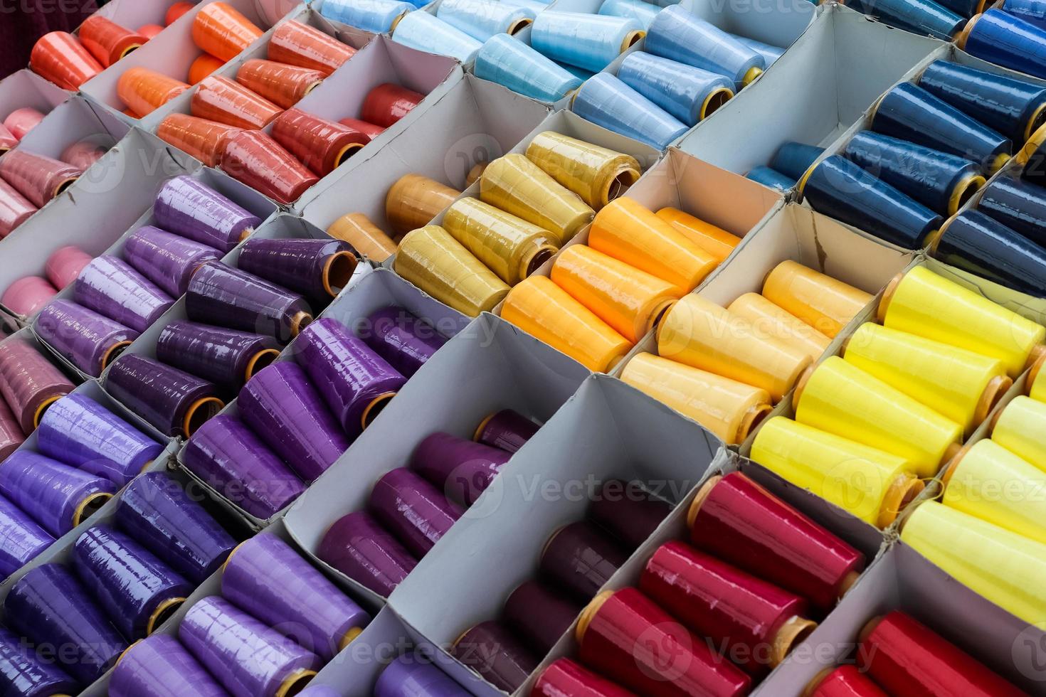 Detailed close up view on samples of cloth and fabrics in different colors found at a fabrics market photo