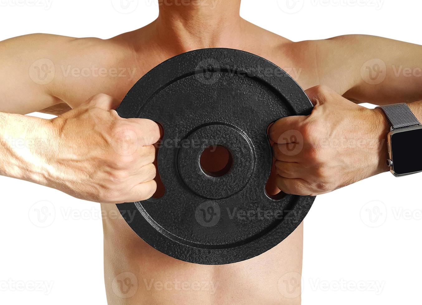 Young man with muscles holding disk weights. photo