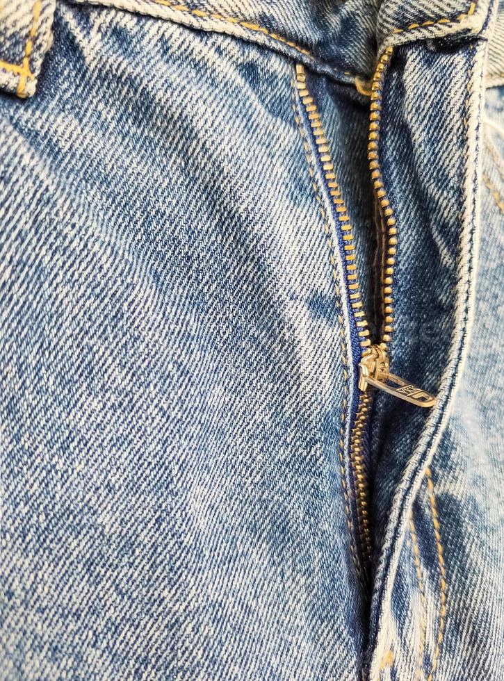 Zipper on jeans. Jeans texture. Unzipped jeans. photo