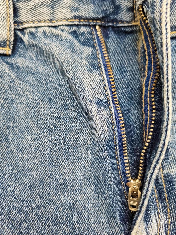 Zipper on jeans. Jeans texture. Unzipped jeans. photo