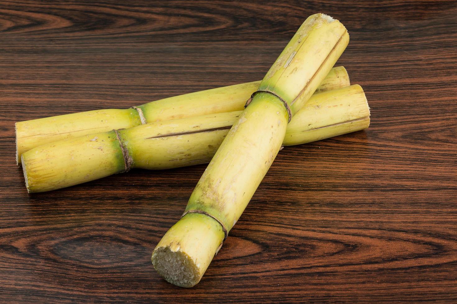 Sugar reed on wooden background photo