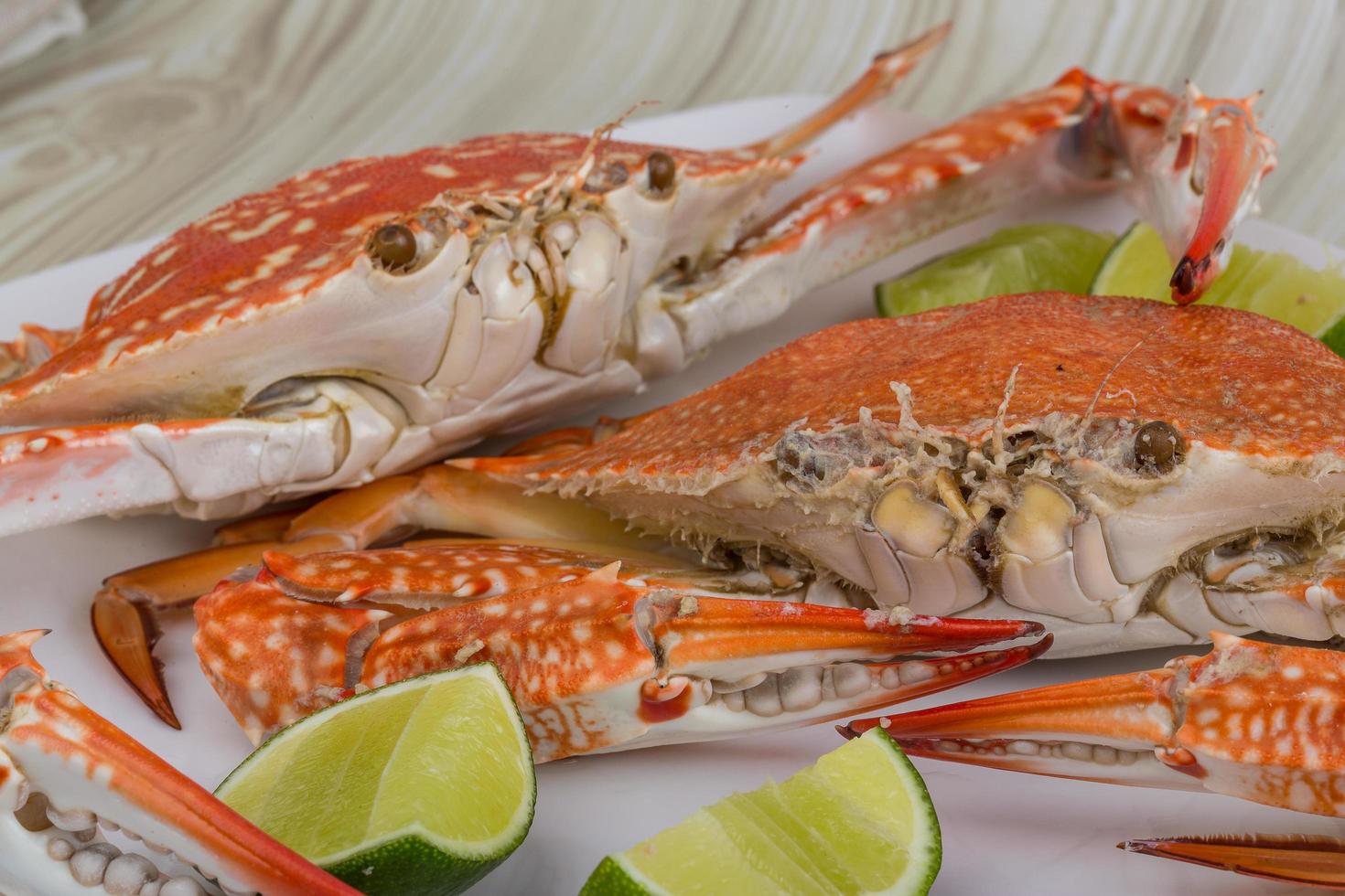Boiled crabs on the plate and wooden background photo